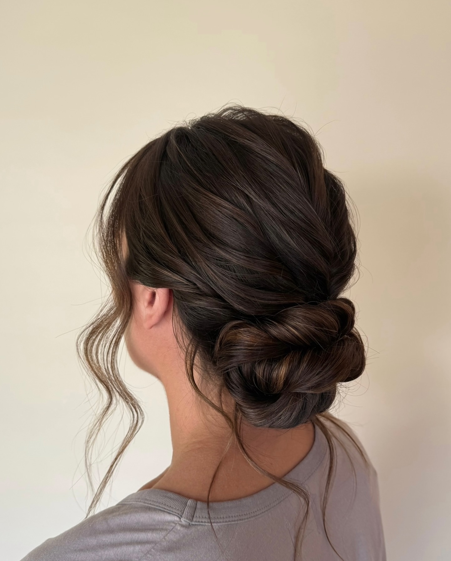 Elegant Twisted Low Chignon with Wispy Ends