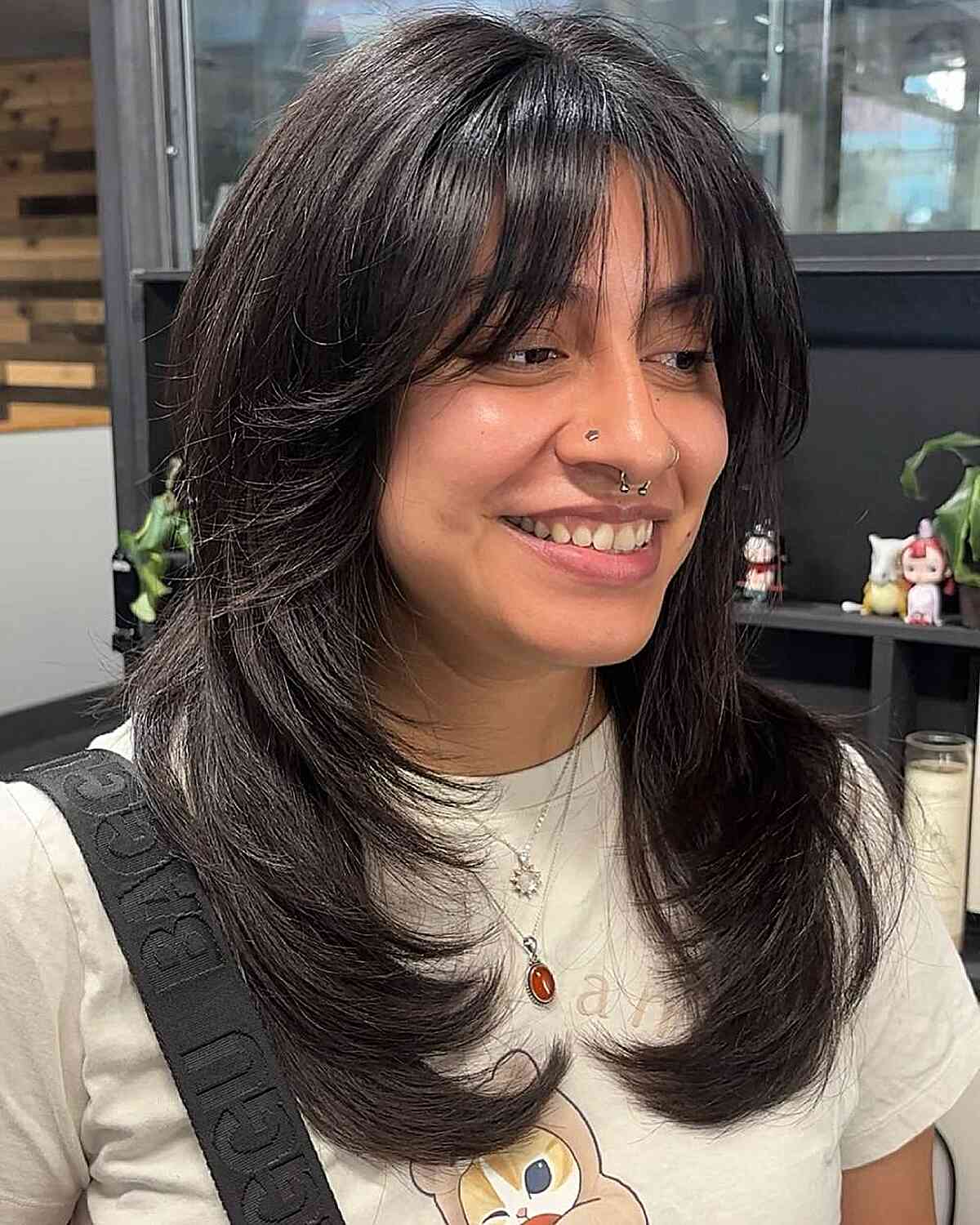 Chic Layered Haircut with Wispy Bangs