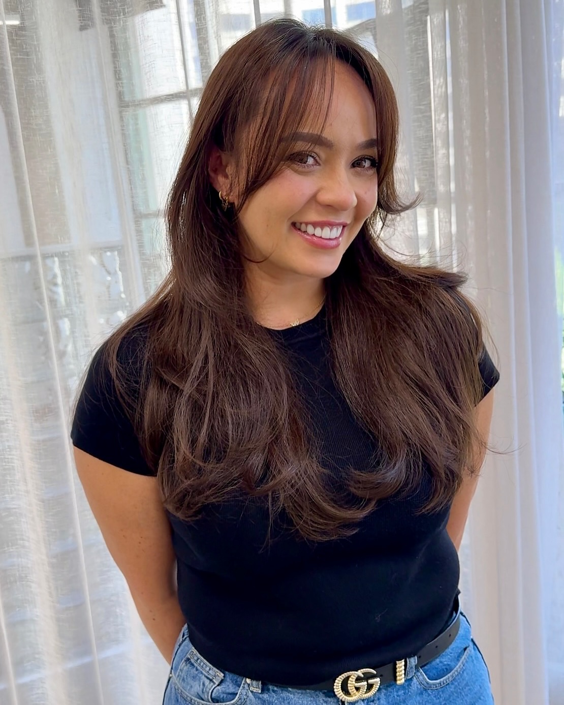 Elegant Long Layers with Soft Brow-Grazing Bangs