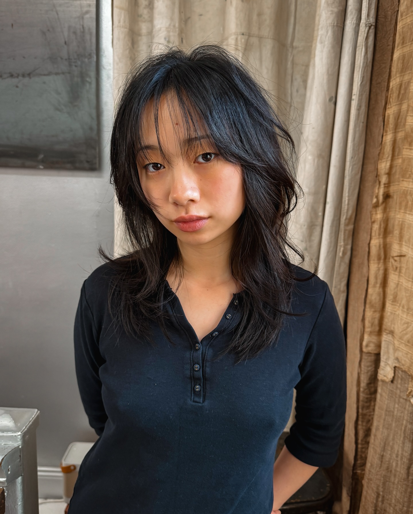 Mid-Length Black Tousled Cut with Wispy Bangs