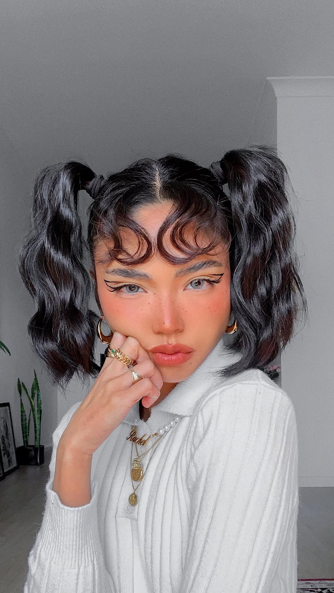 Playful Black Pigtails with Soft Waves and Tendril Accents