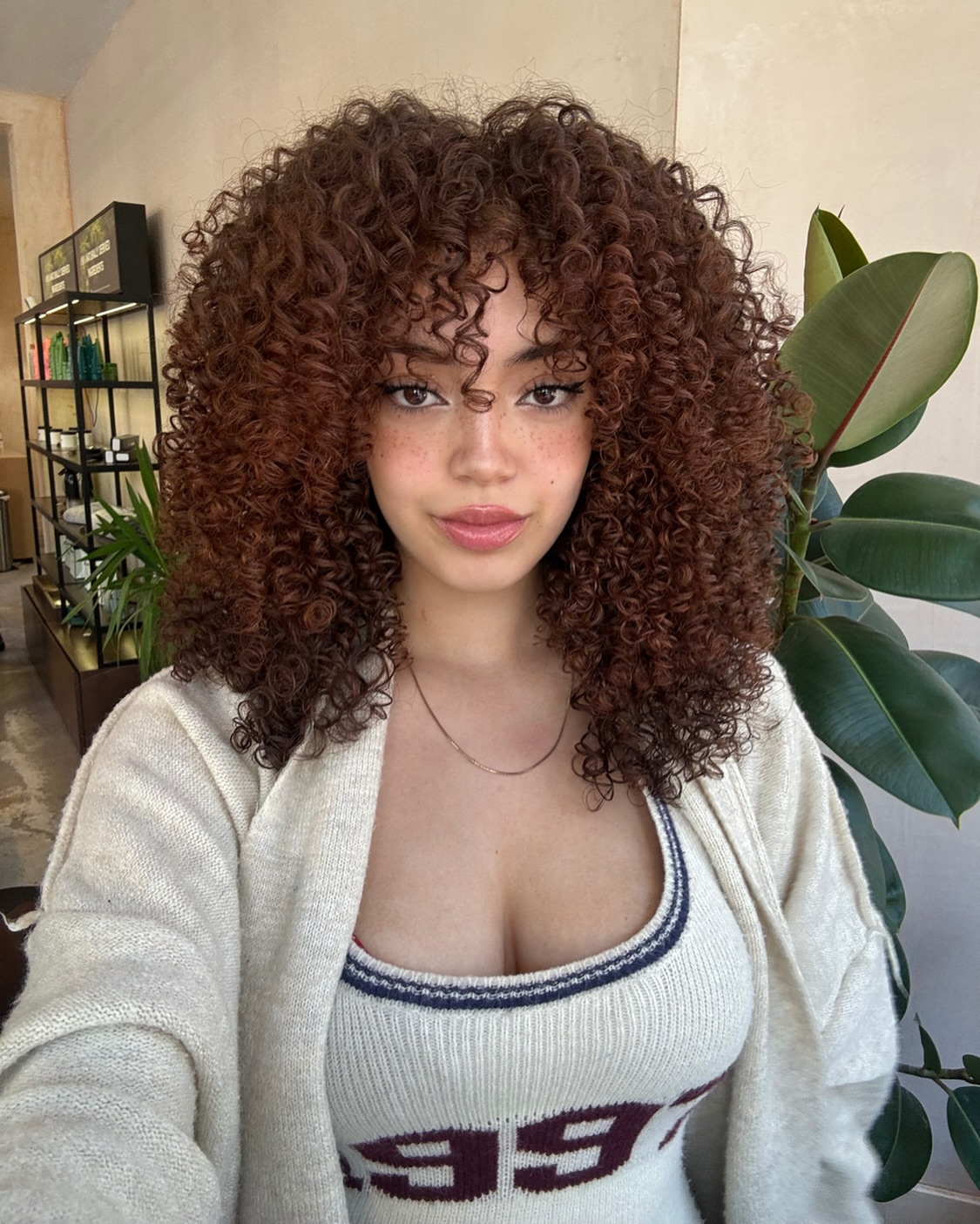 Voluminous Chestnut Curls with Natural Highlights