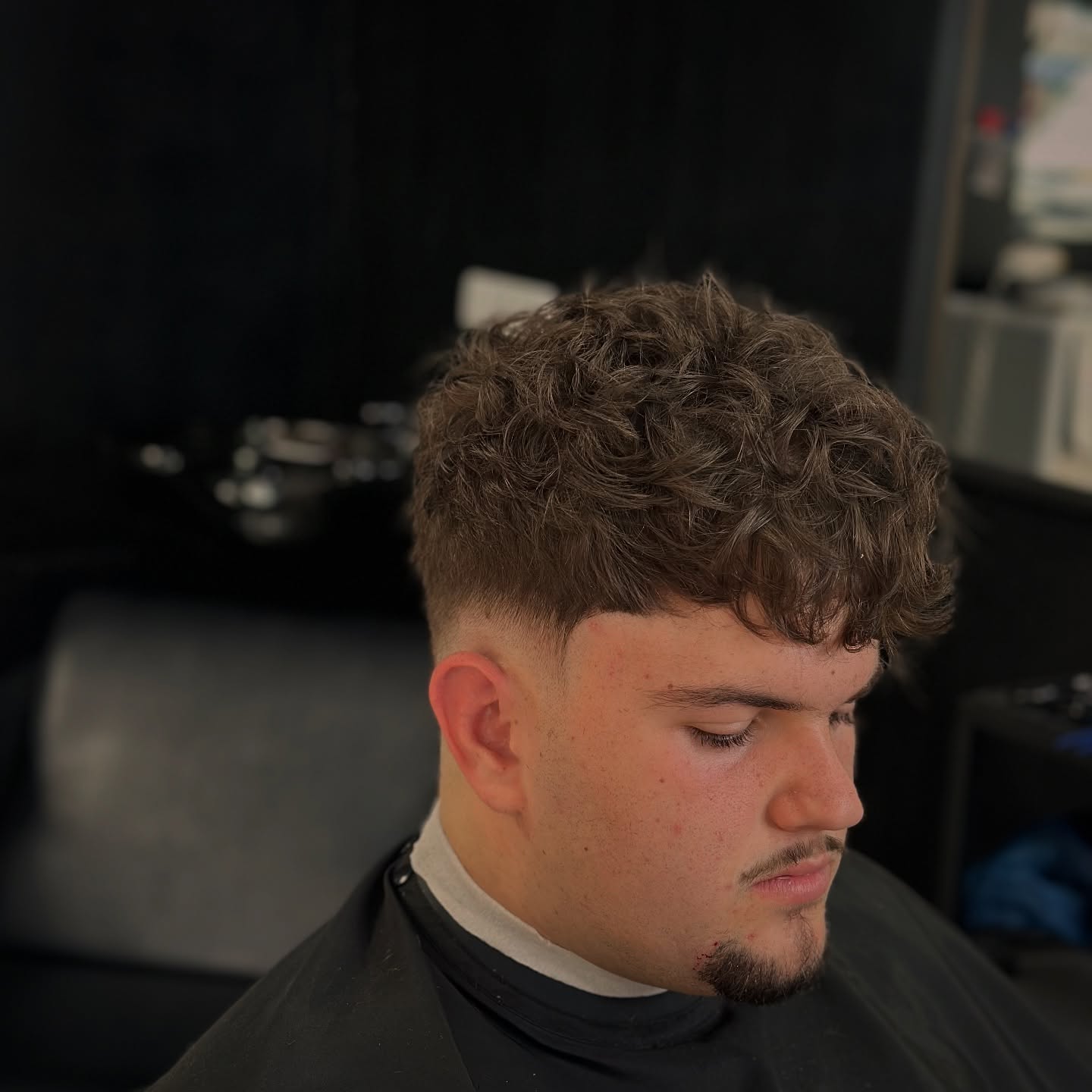 Voluminous Curly Quiff with Defined Low Fade
