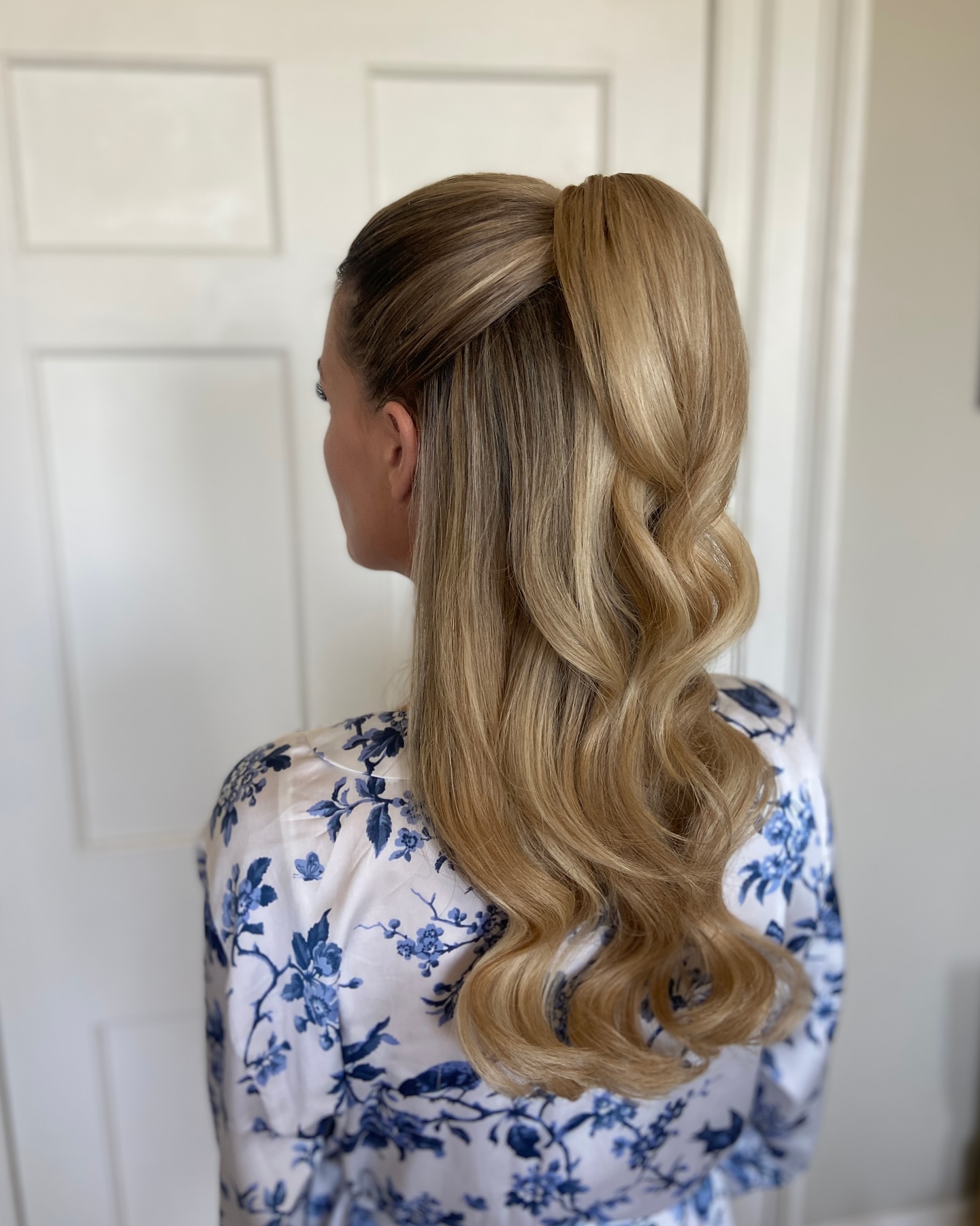 Elegant Blonde Waves with Smooth Half-Up Twist