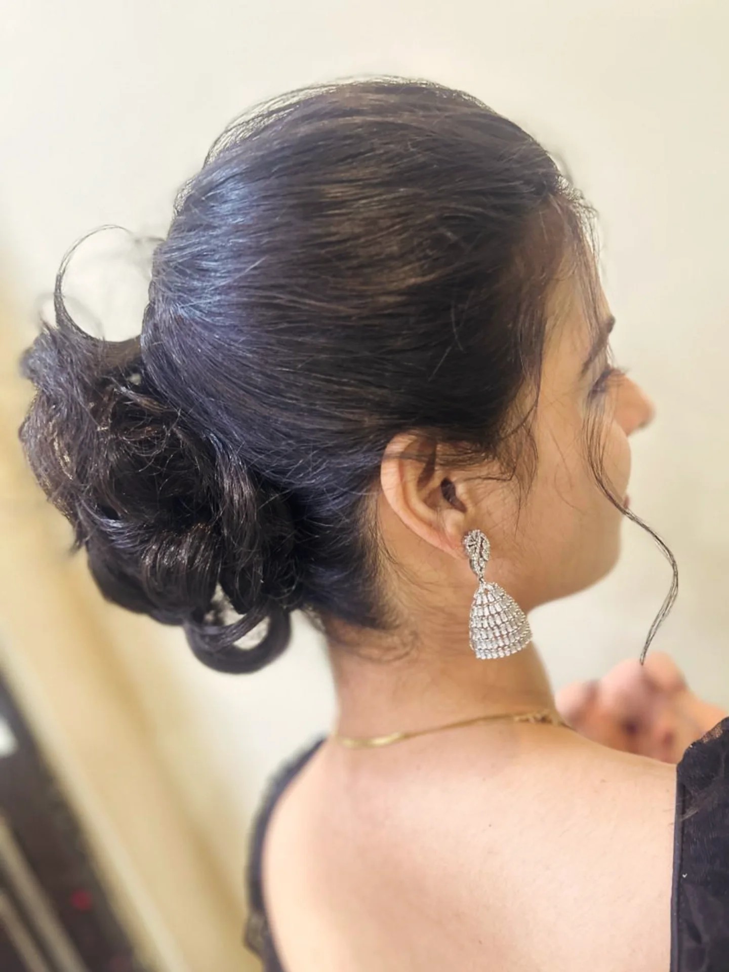 Elegant Low Chignon with Wispy Escape