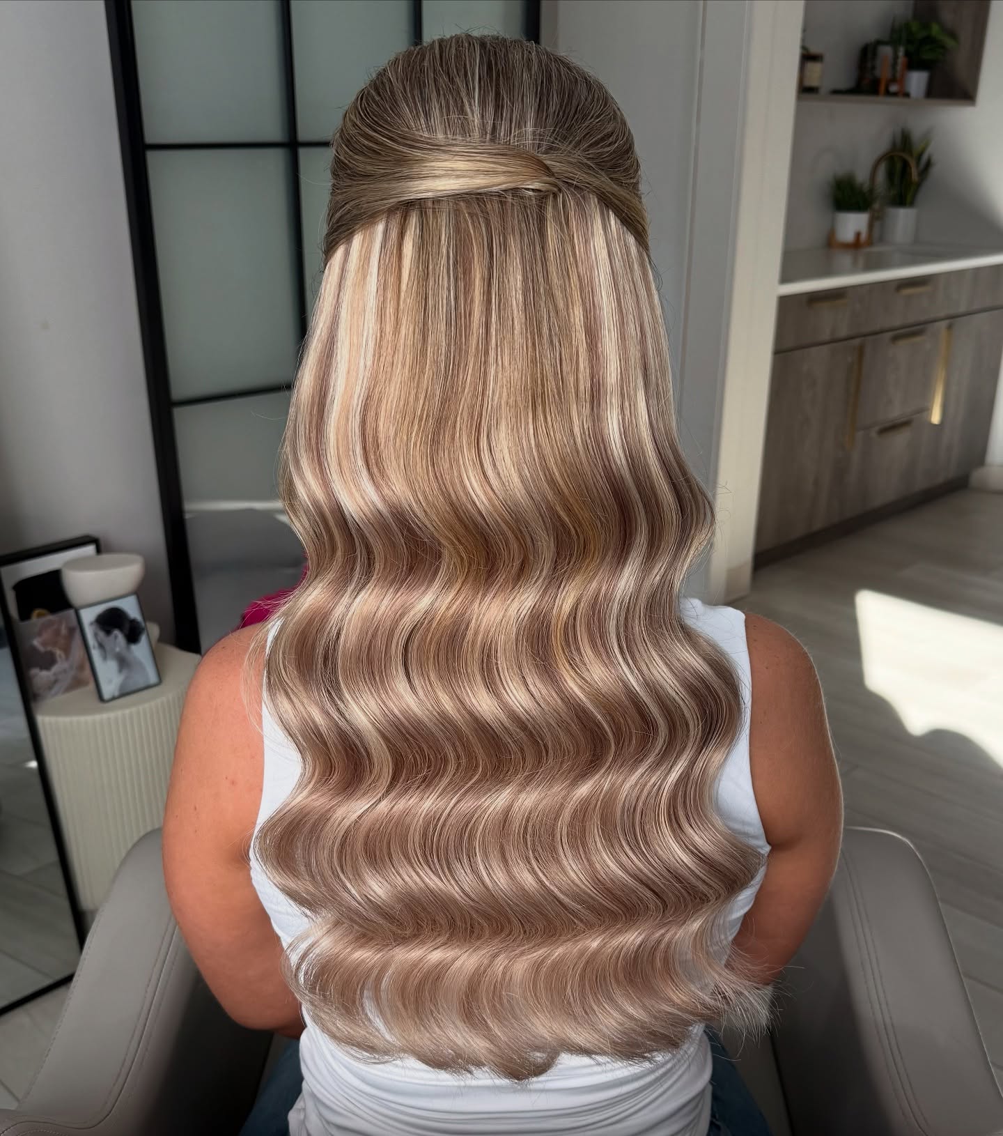 Gleaming Rose-Gold Waves with Sleek Half-Up Style