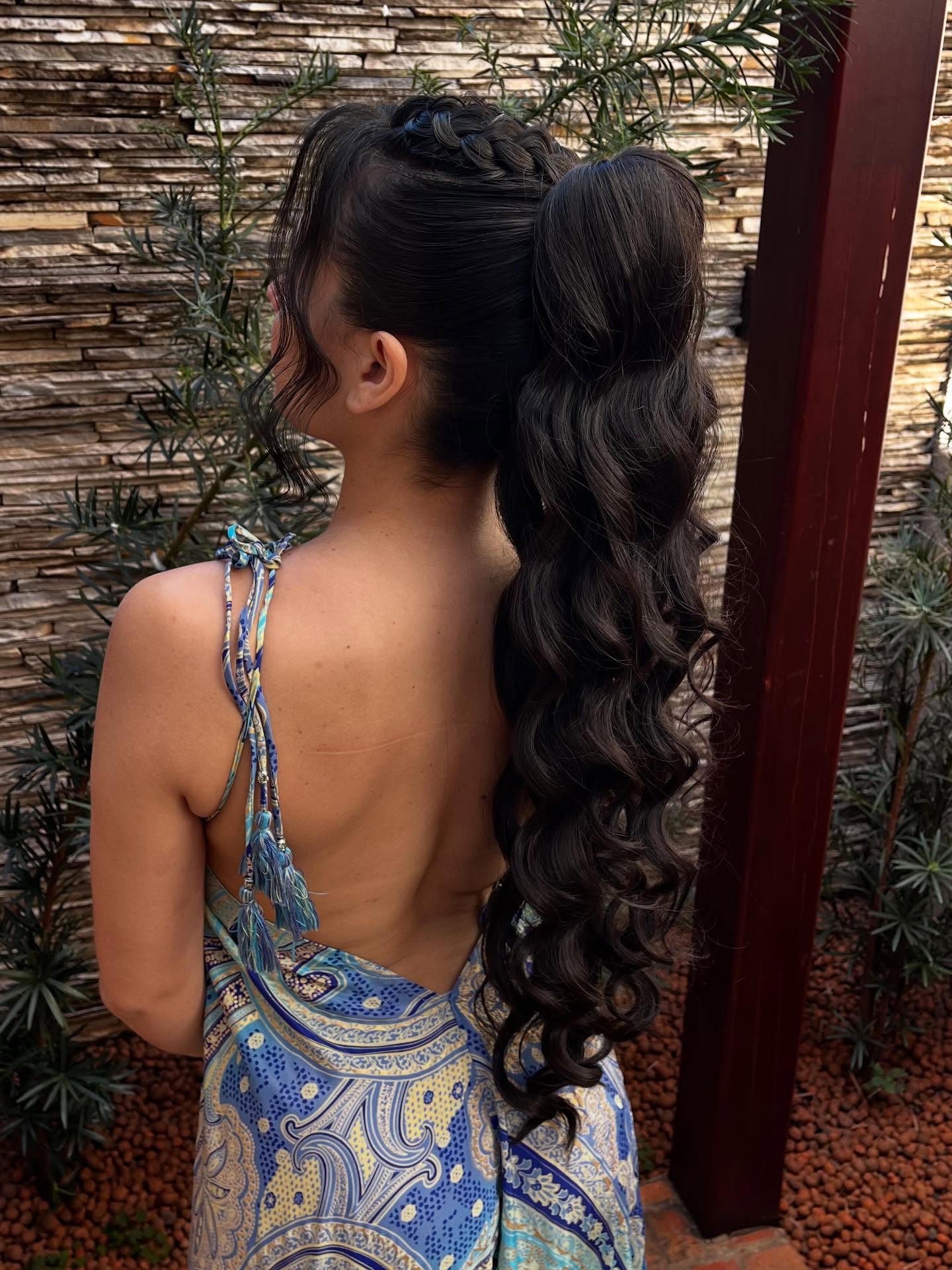 Playful High Ponytail with Braided Crown and Loose Curls
