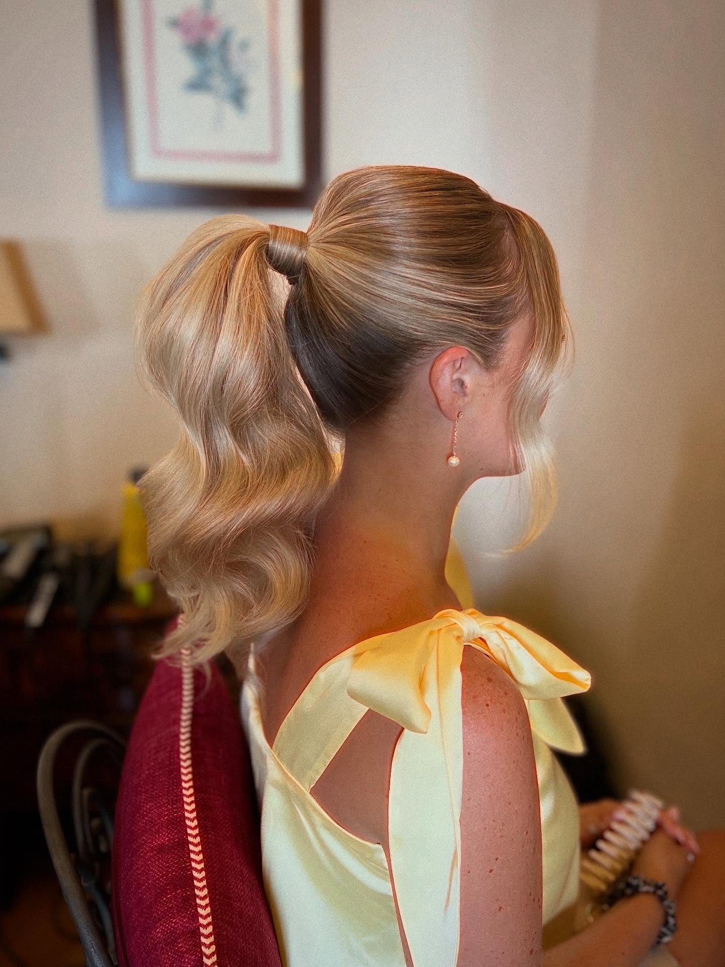 Polished Ponytail with Cascading Golden Waves