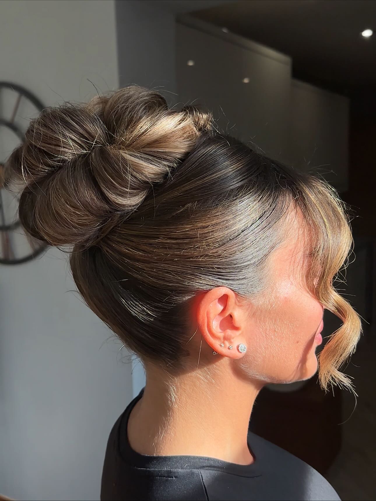 Elegant Brunette Bun with Soft Blonde Highlights