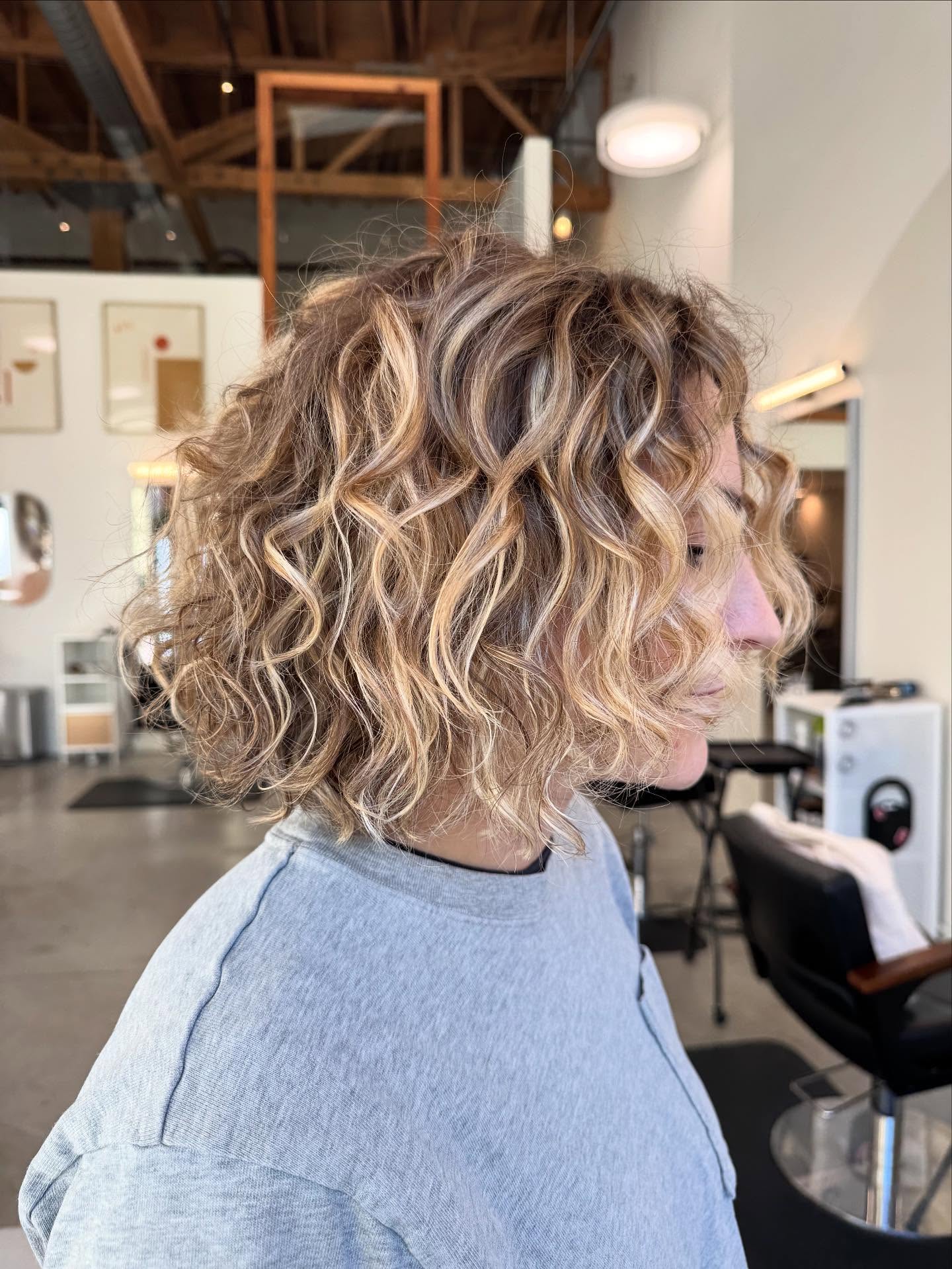 Playful Curly Bob with Sun-Kissed Highlights