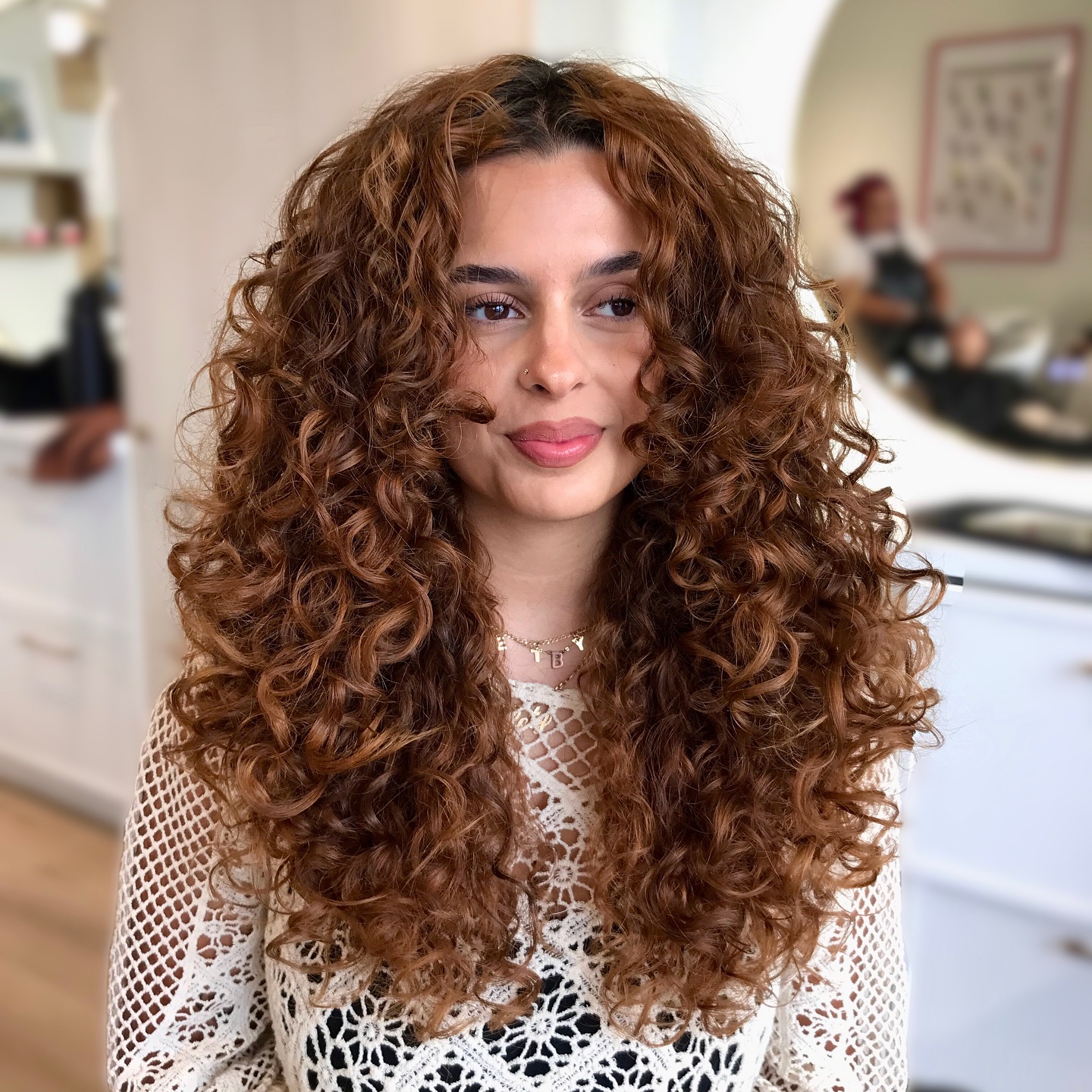Sumptuous Cinnamon Spiral Curls with Subtle Layers
