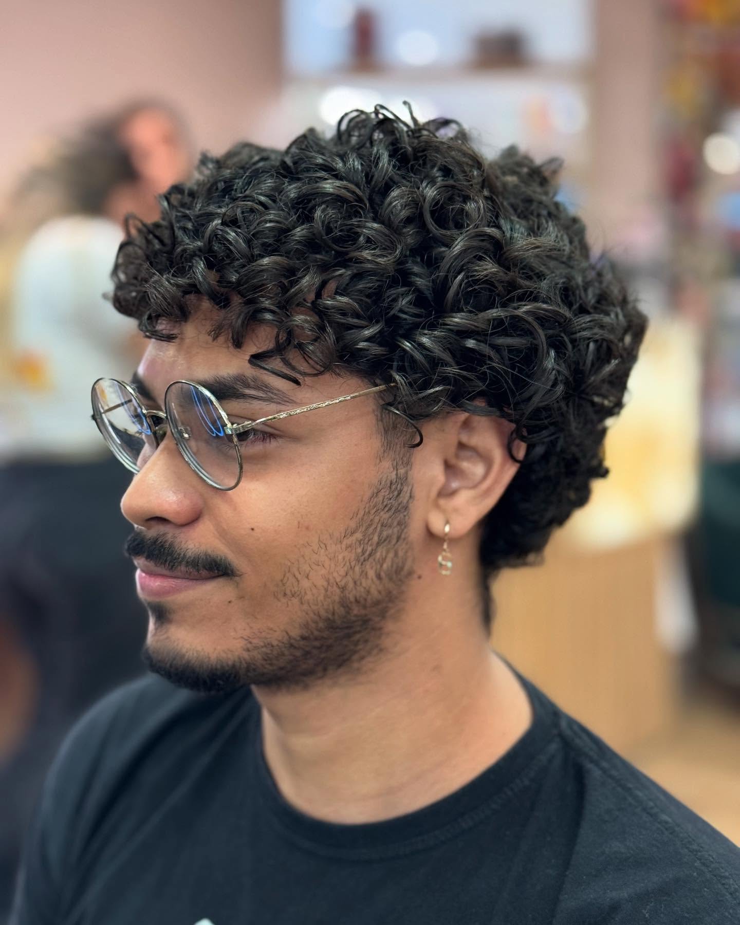 Artistically Styled Dense Curly Top with Subtle Taper