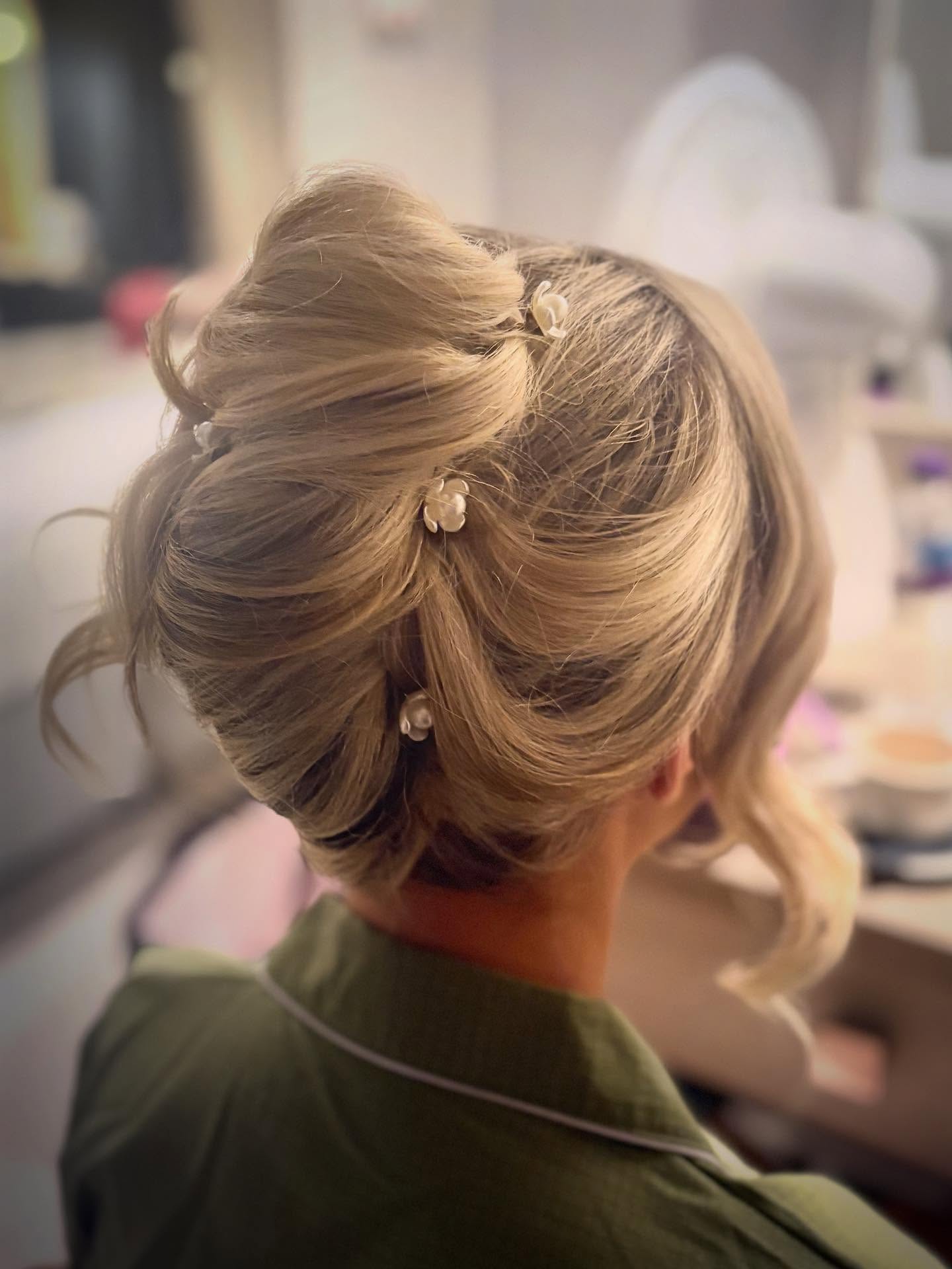 Elegant Blonde Bun with Delicate Floral Accents