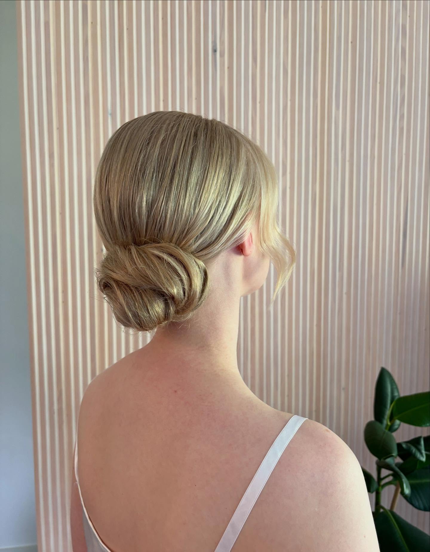 Refined Low Chignon with Soft Blonde Highlights