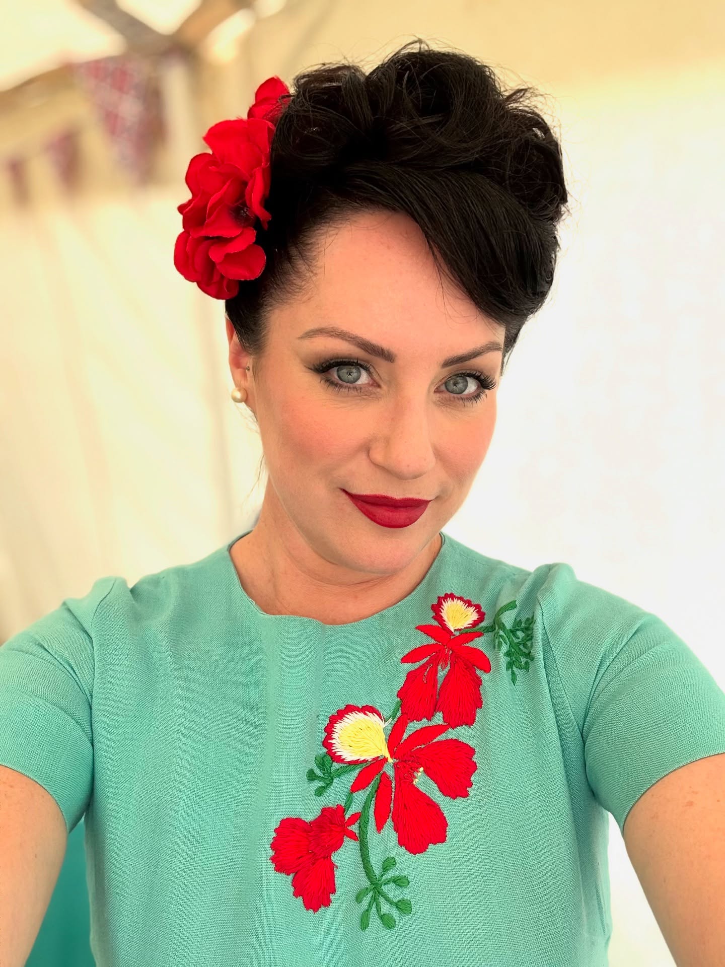 Charming Black Updo with Vibrant Floral Accent