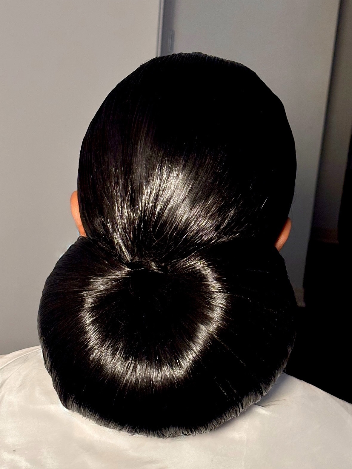 Sleek Polished Bun with Central Twist Accent