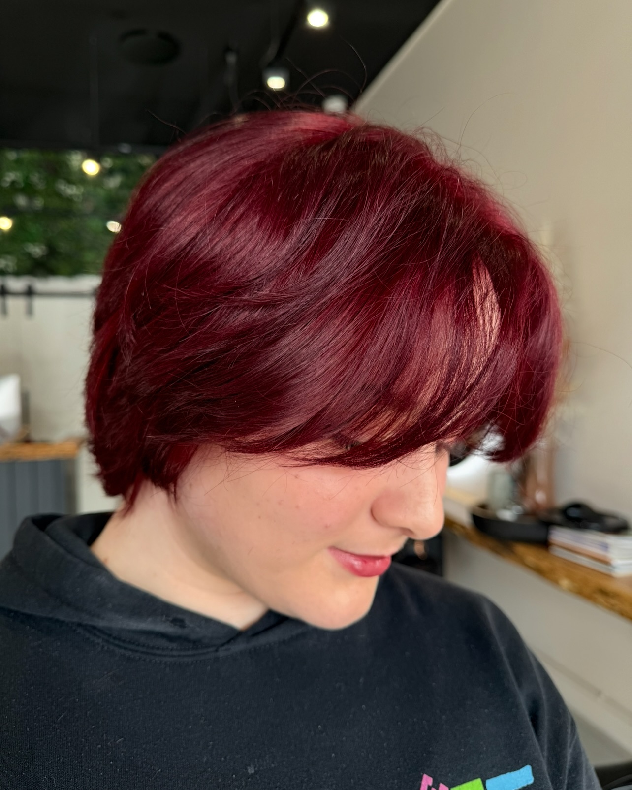 Glossy Deep Red Layered Bob with Side-Swept Bangs
