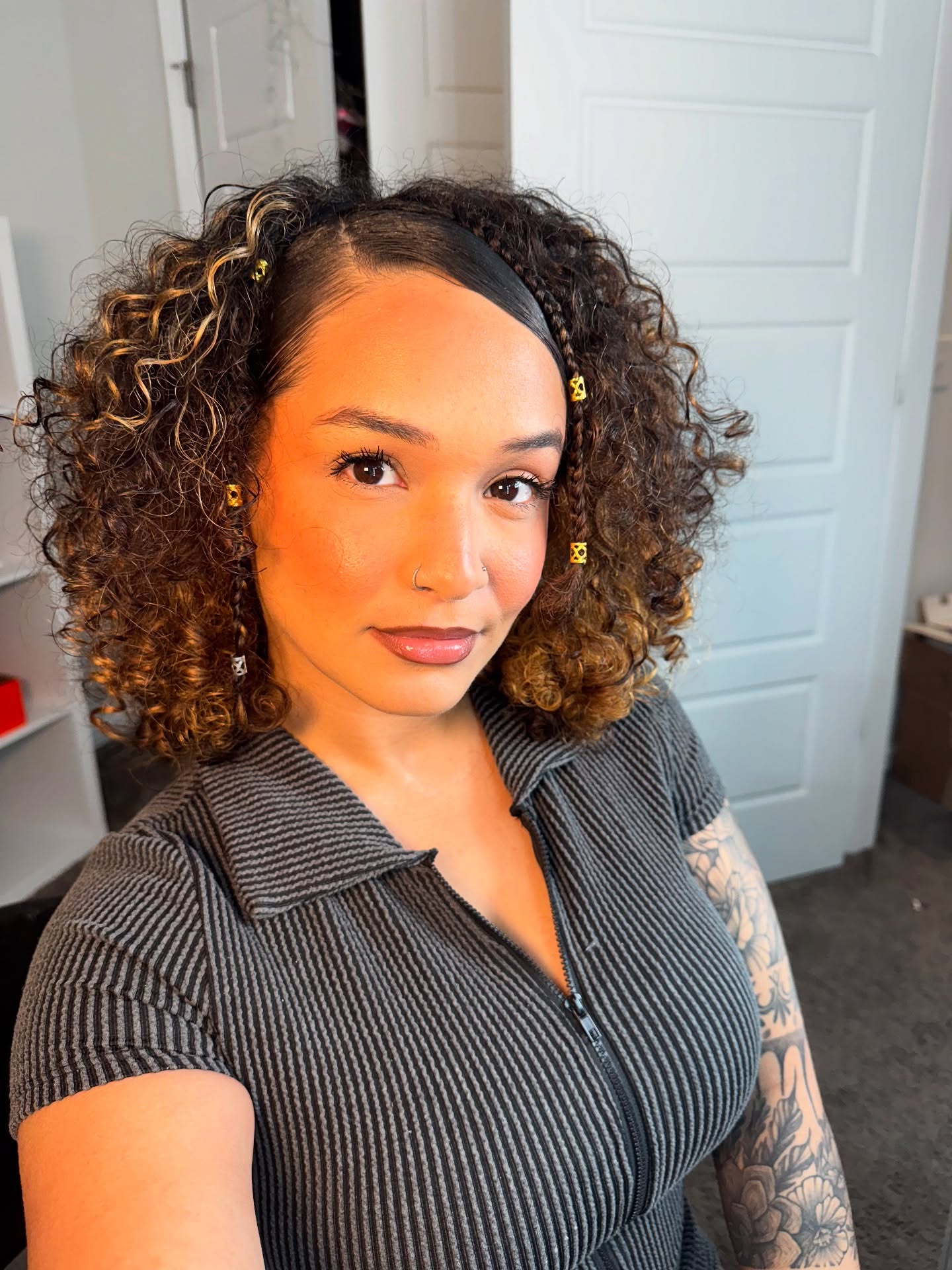 Golden-Highlighted Curly Bob with Floral Accents