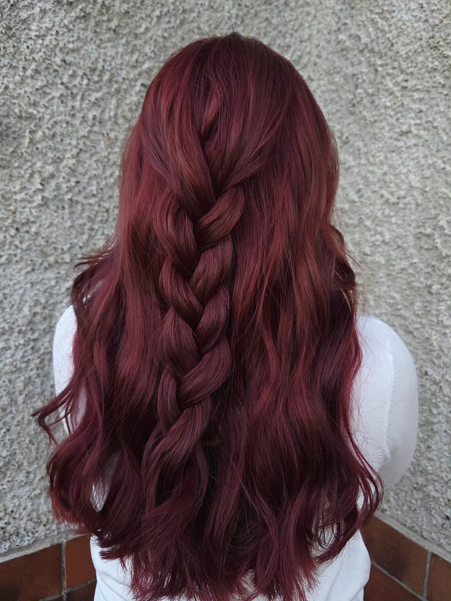 Intricate Burgundy Braid on Long Tousled Waves