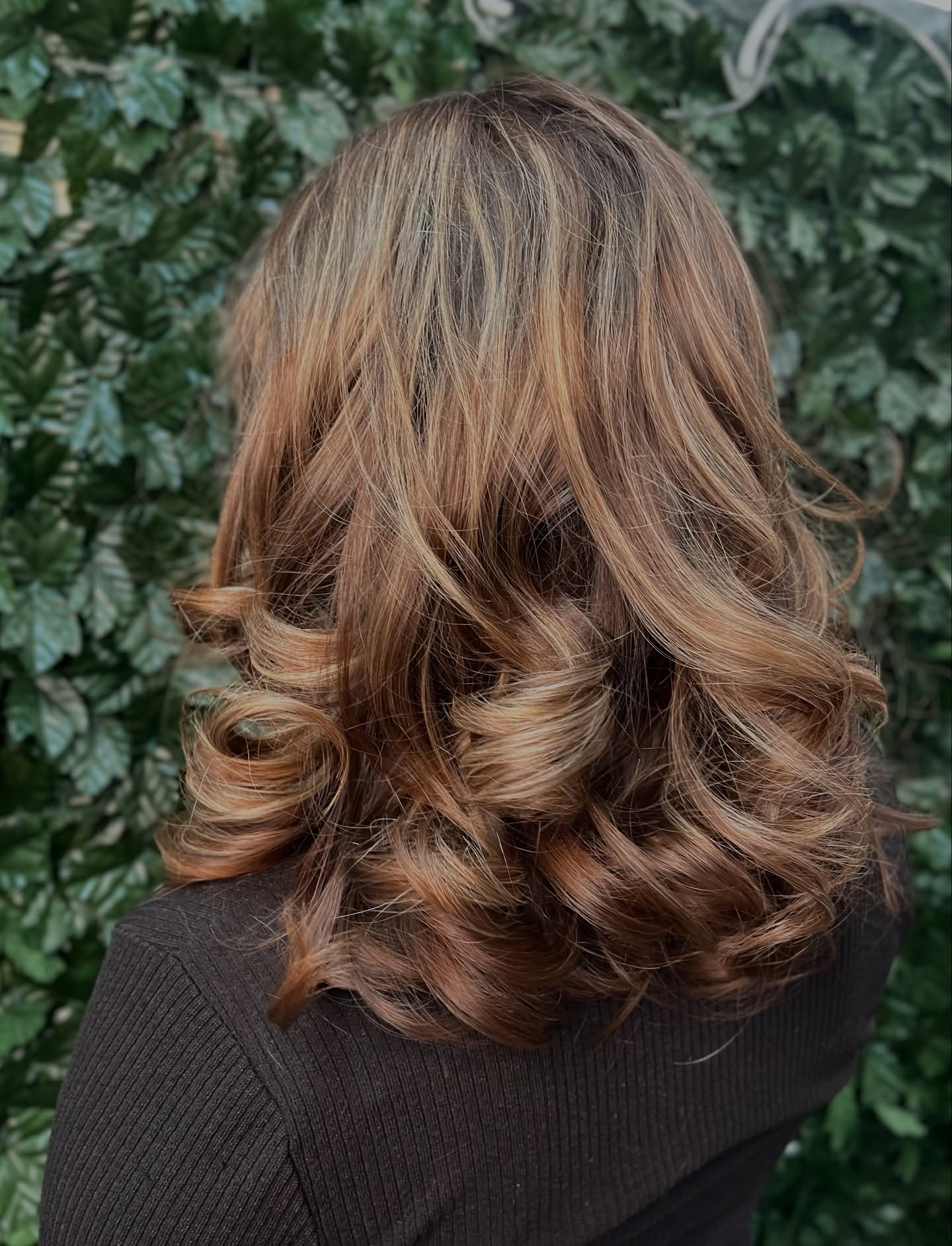 Radiant Cascading Curls with Warm Highlights