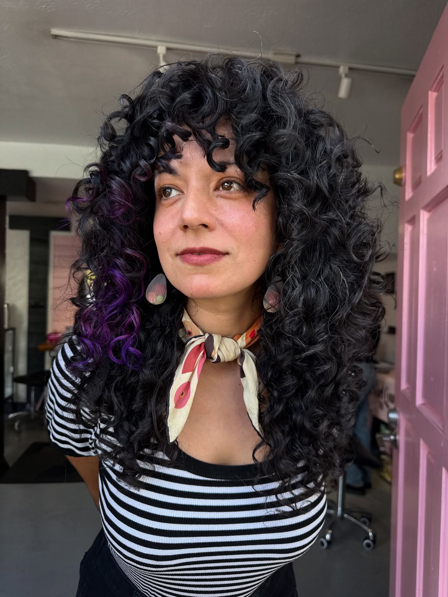 Bold Curly Wolfcut with Vibrant Highlights