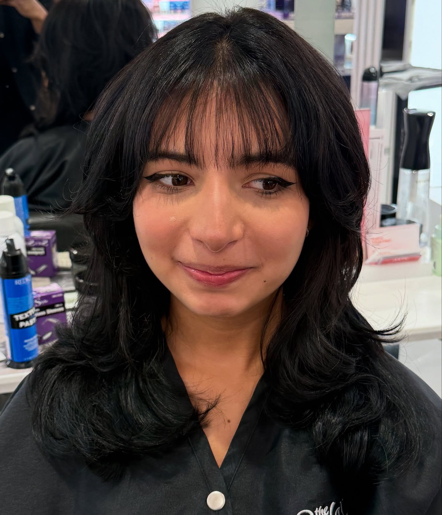 Deep Black Cascading Curls with Face-Framing Bangs