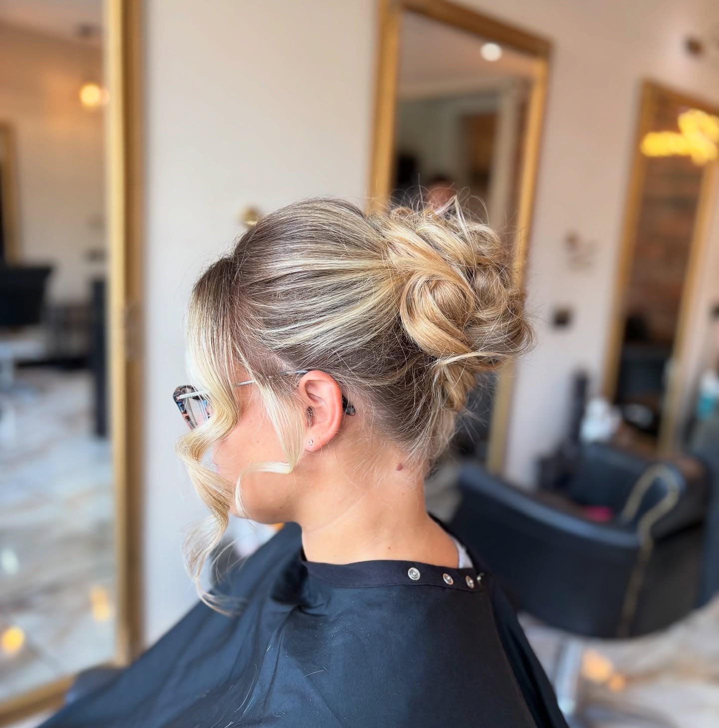 Efficient Blonde Balayage Bun with Loose Strands