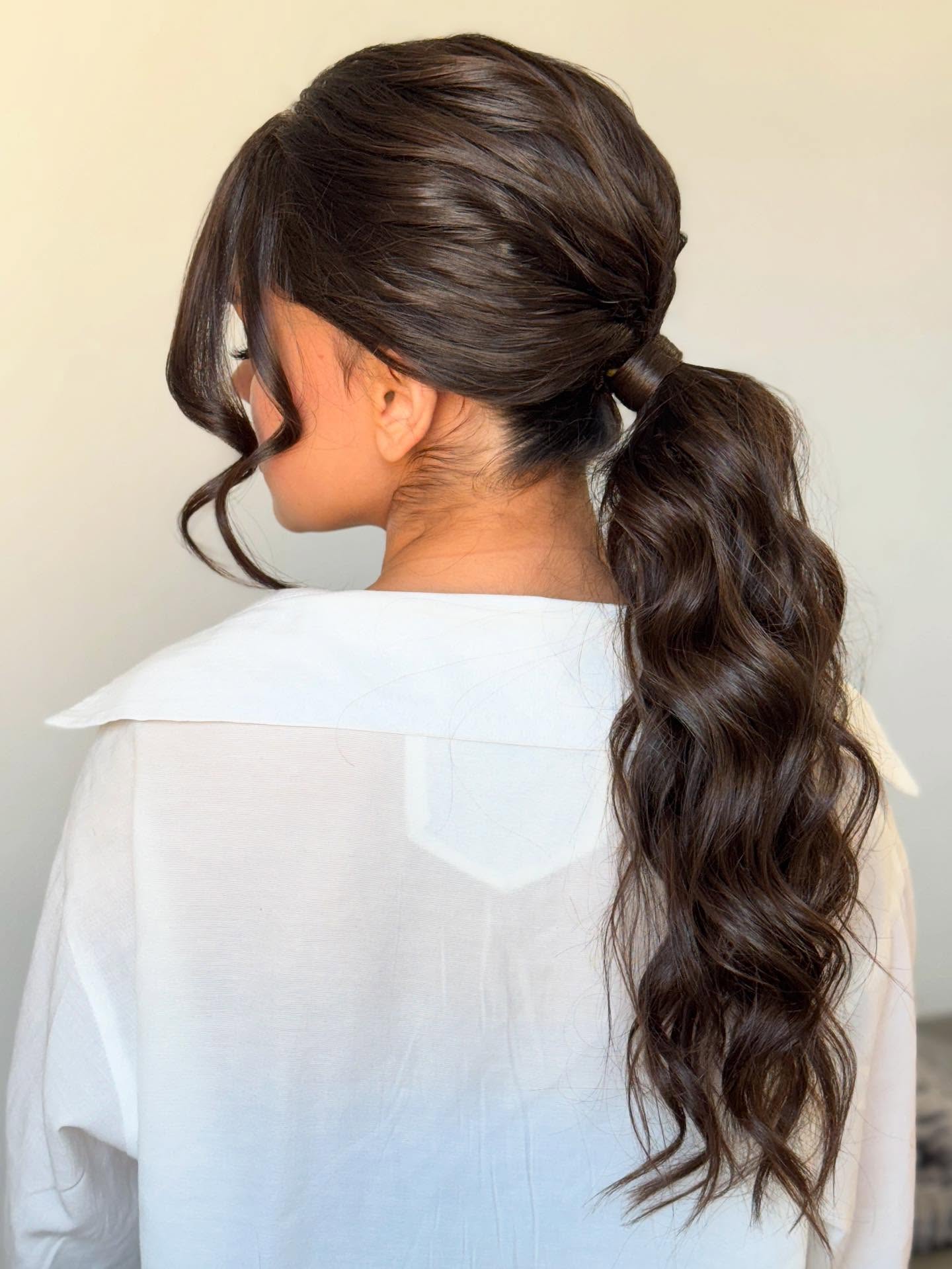 Elegant Swept-Back Ponytail with Textured Curls