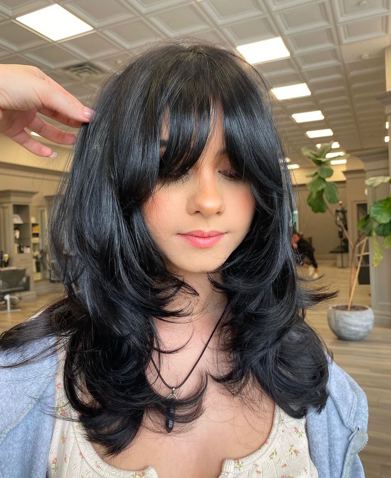 Jet-Black Flowing Layers with Bangs