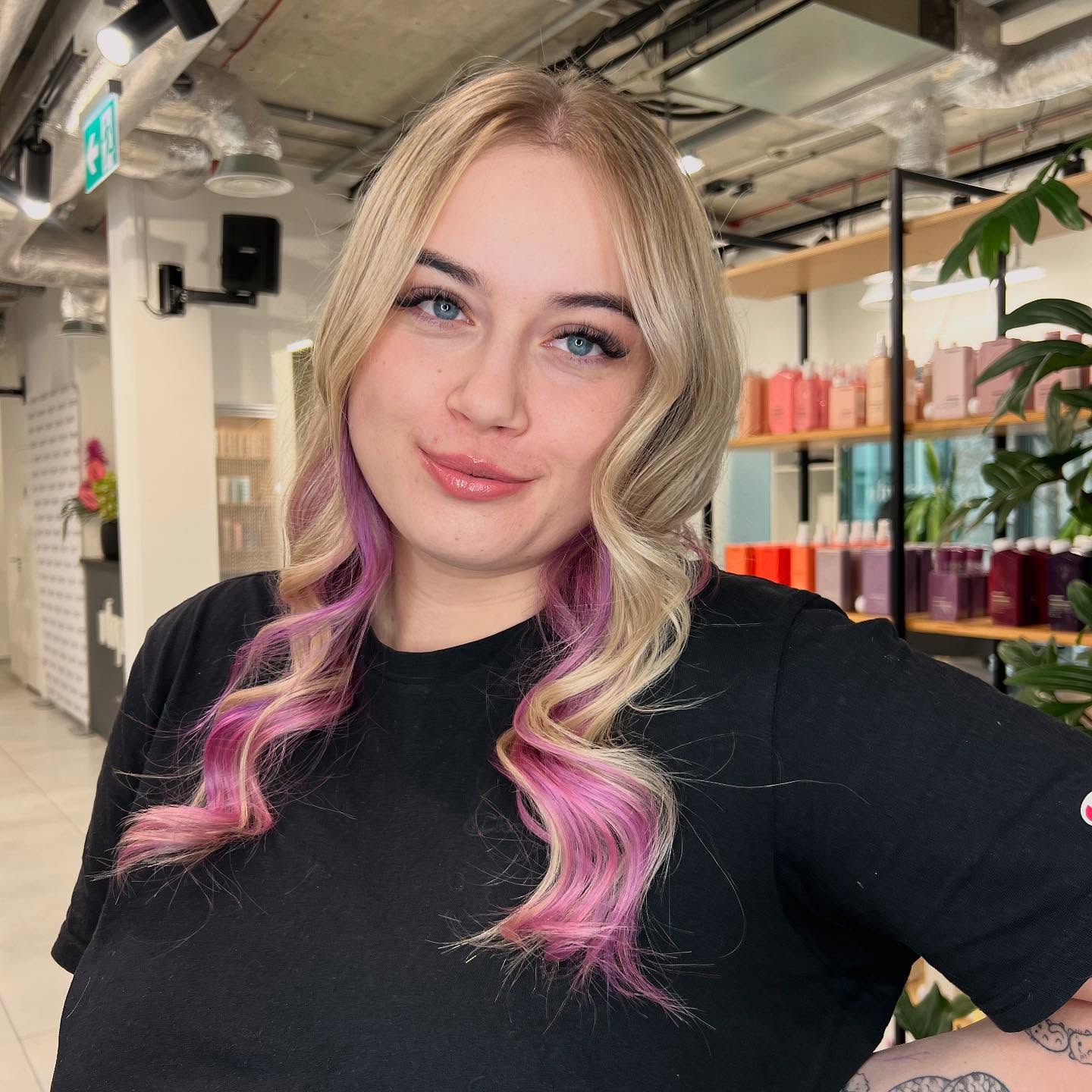 Layered Blonde Waves with Playful Pink Accents