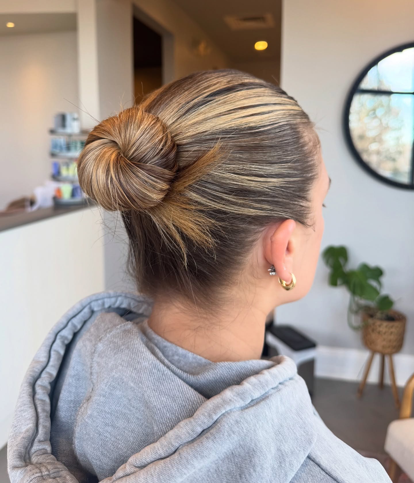 Sleek Slicked-Back Bun with Blonde Highlights