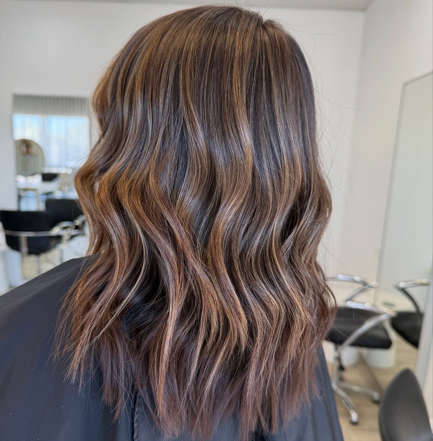 Stylish Long Brunette Waves with Warm Highlights