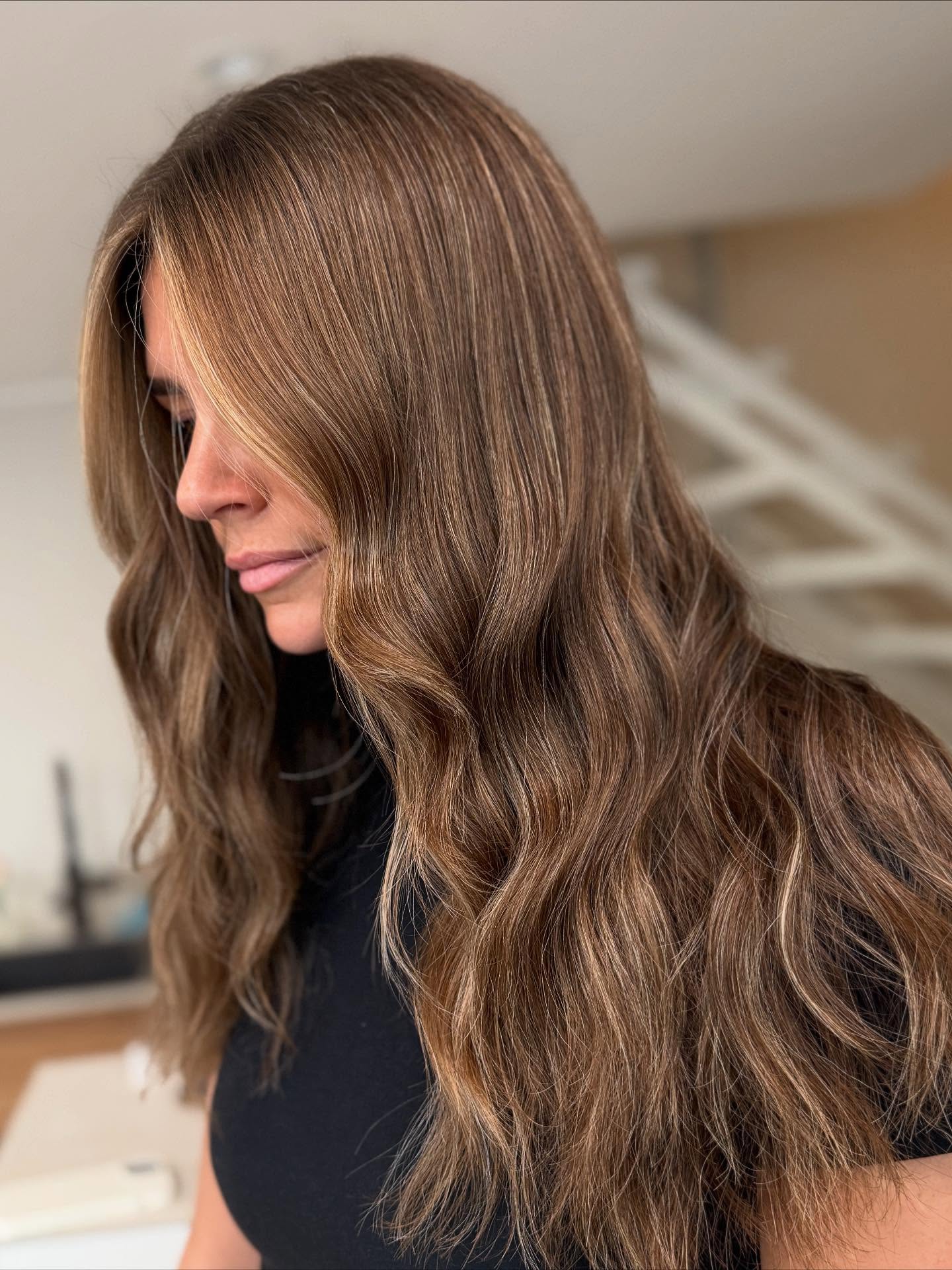 Sunlit Blonde Balayage on Luscious Wavy Locks