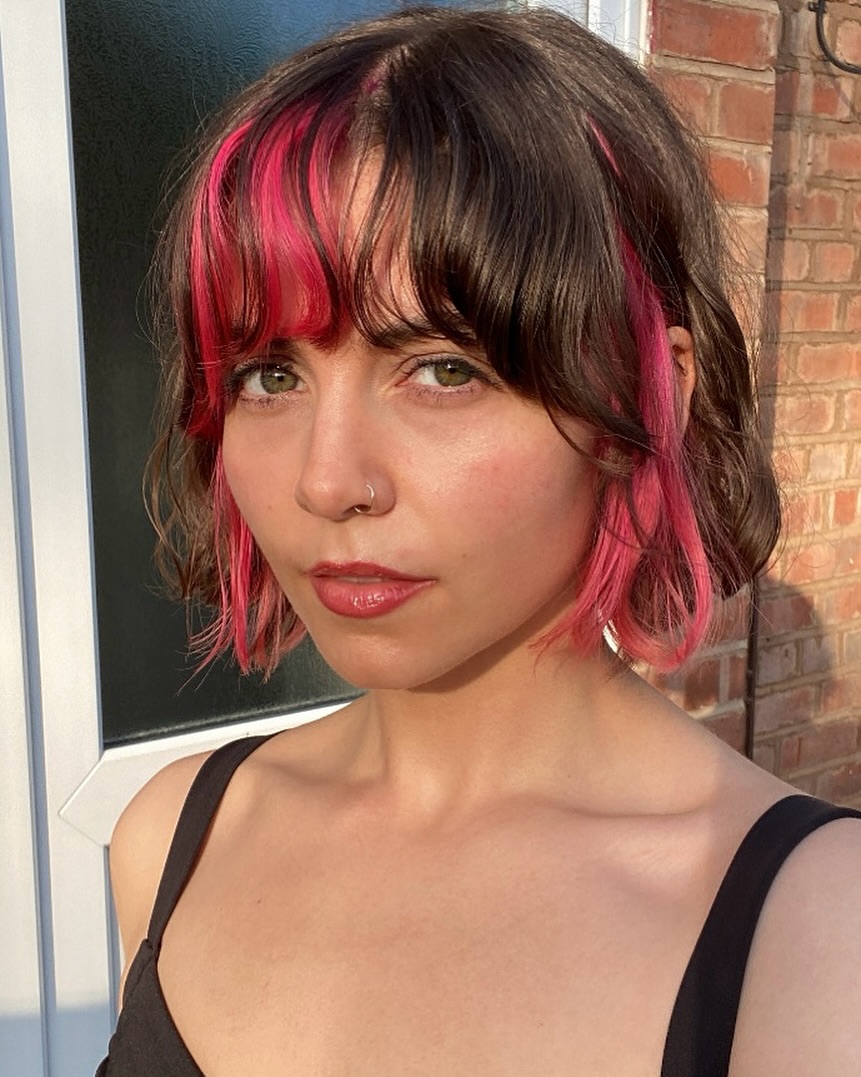 Edgy Curly Bob with Bold Pink Streaks