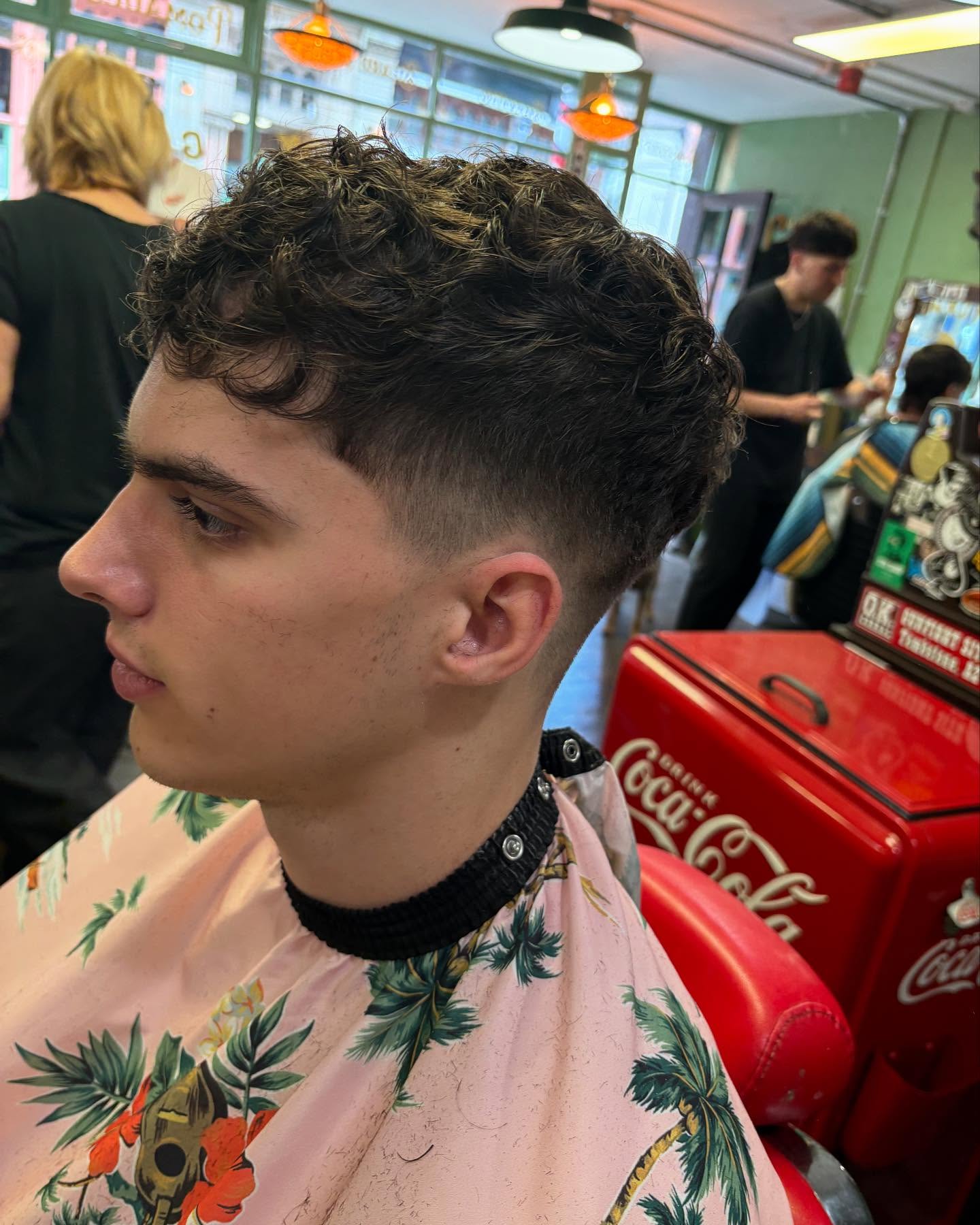Curly Taper Fade with Artistic Shaved Lines