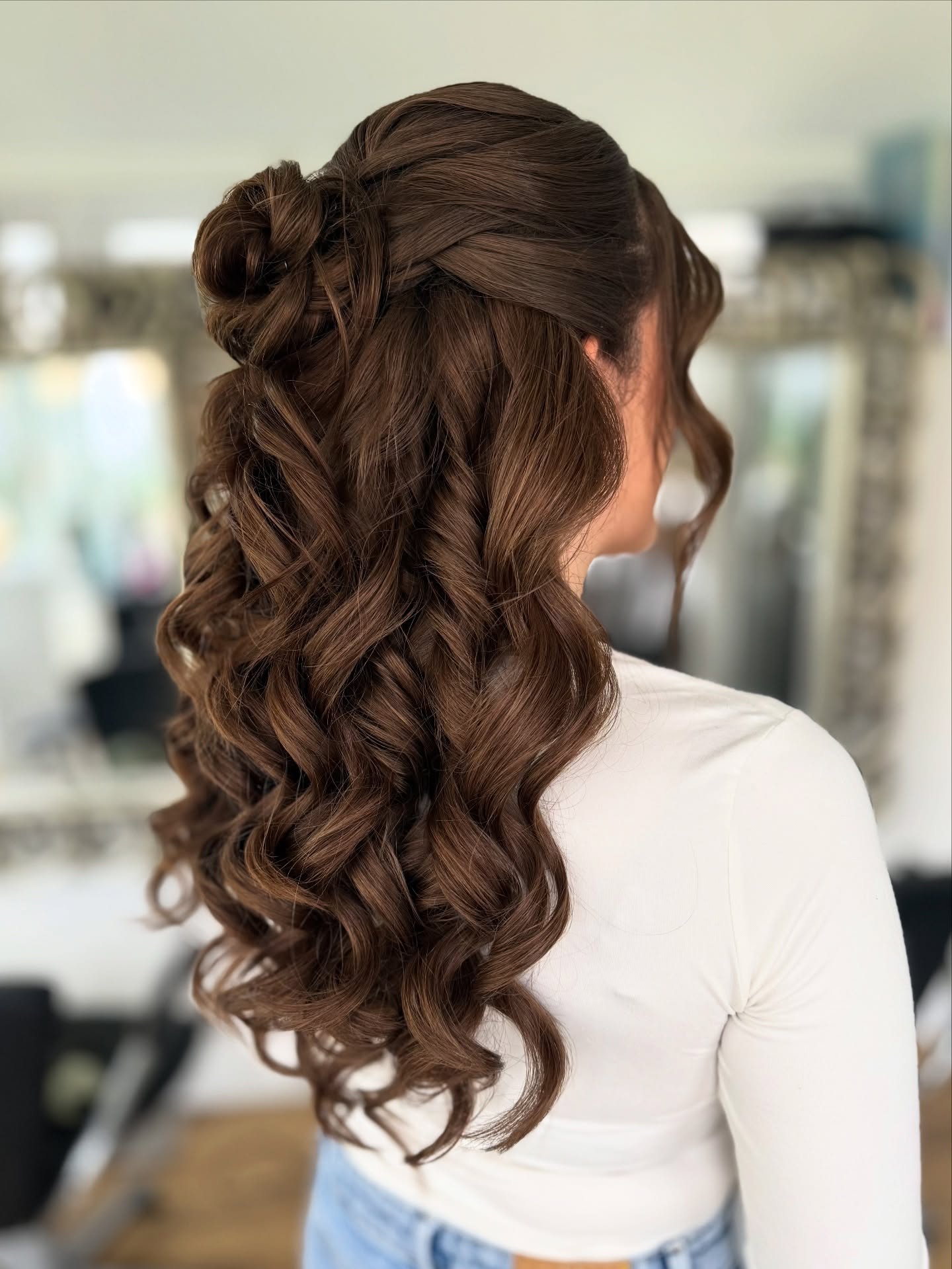Luxurious Chestnut Curls with Floral Accent
