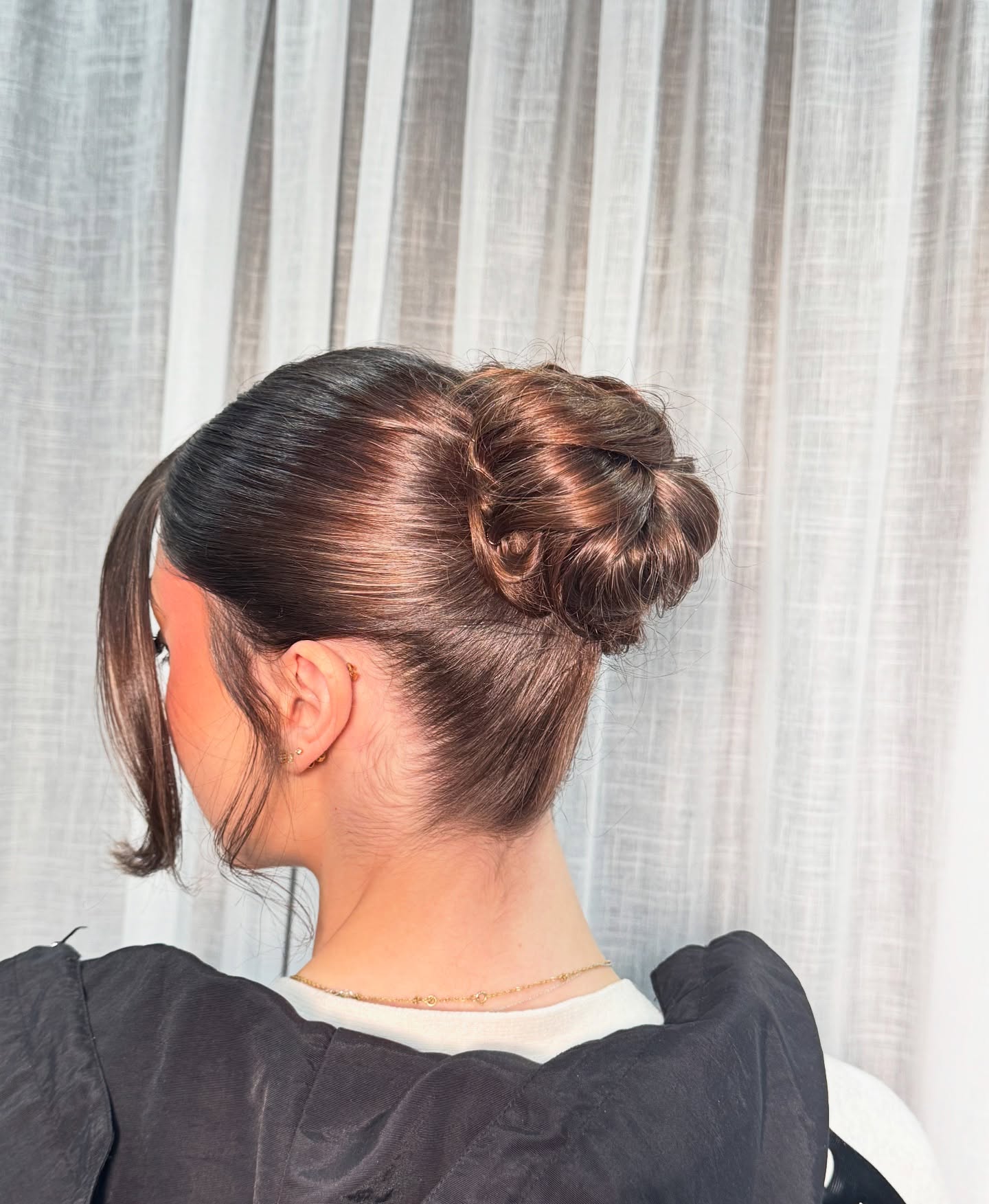 Polished Cocoa Brunette Bun with Subtle Twists
