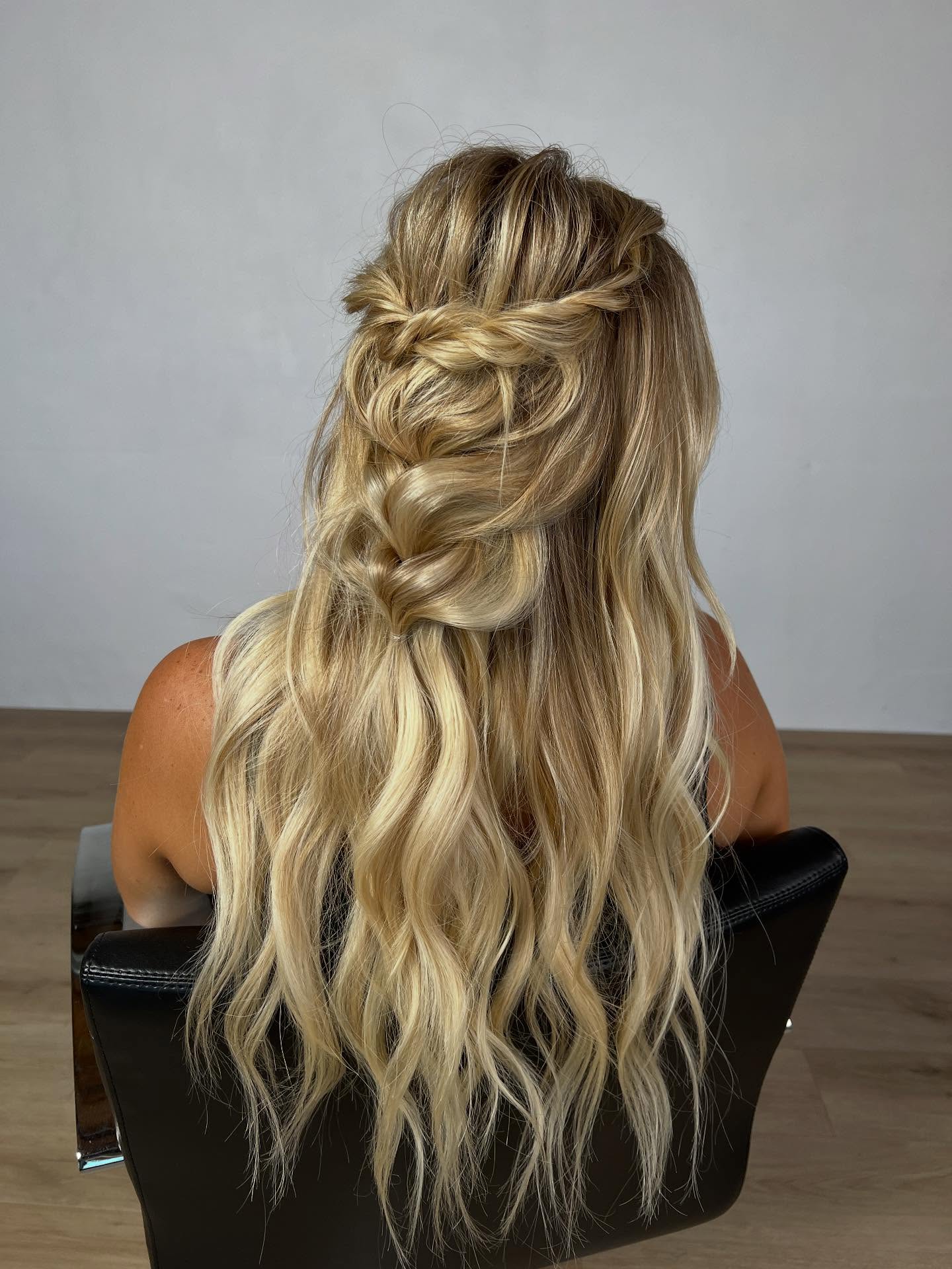 Whimsical Blonde Cascade with Loose Braid Highlights