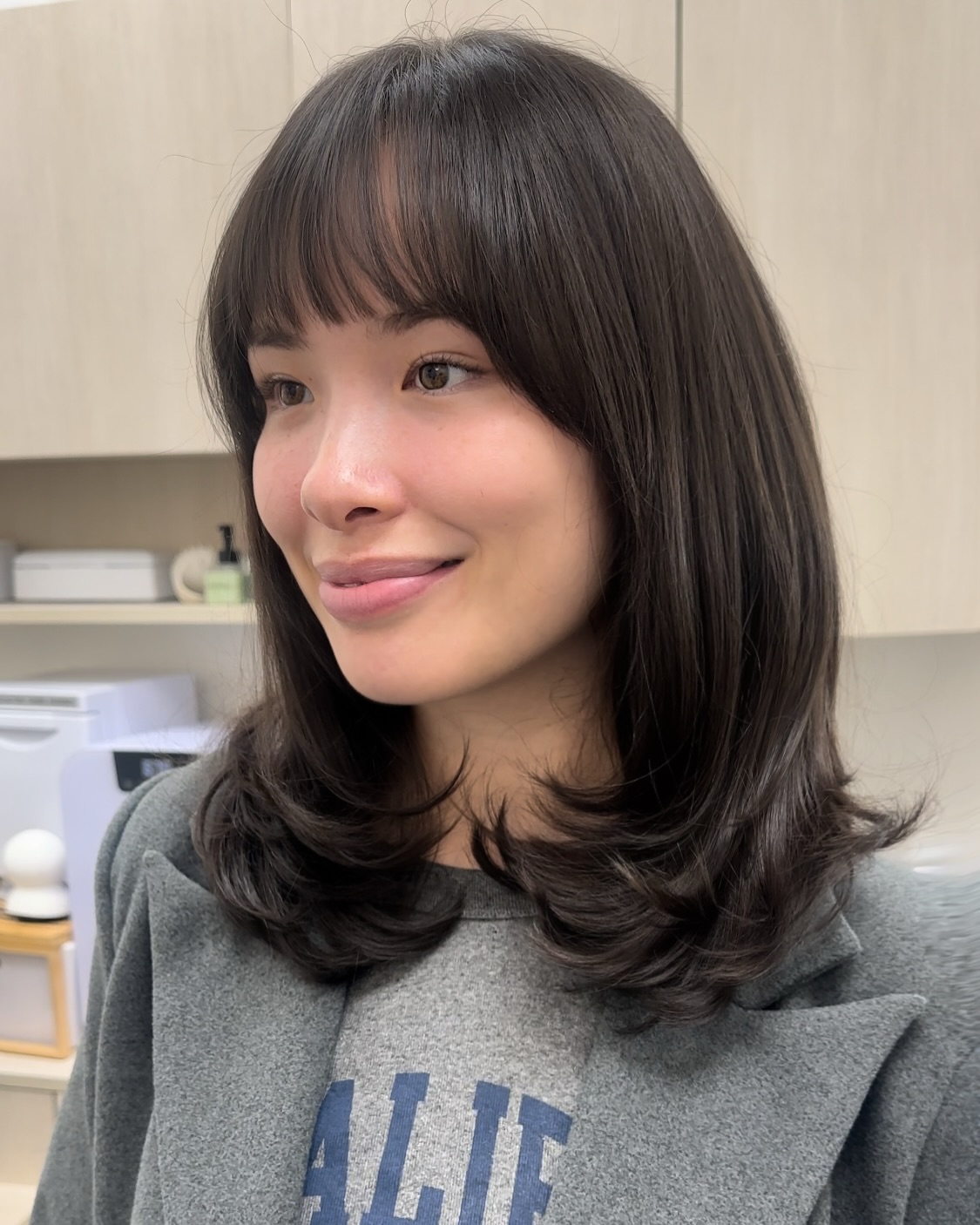 Chic Brunette Bob with Soft Bangs and Curled Ends