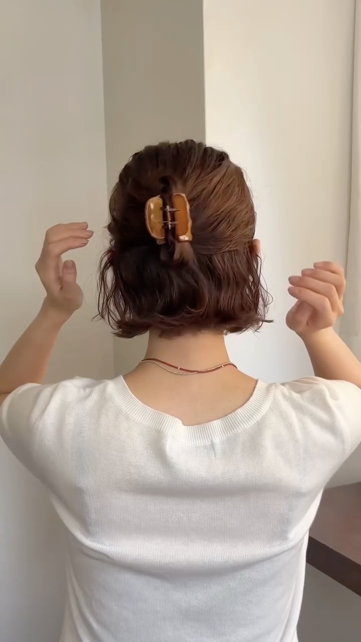 Chic Short Curly Bob with Elegant Hair Clip