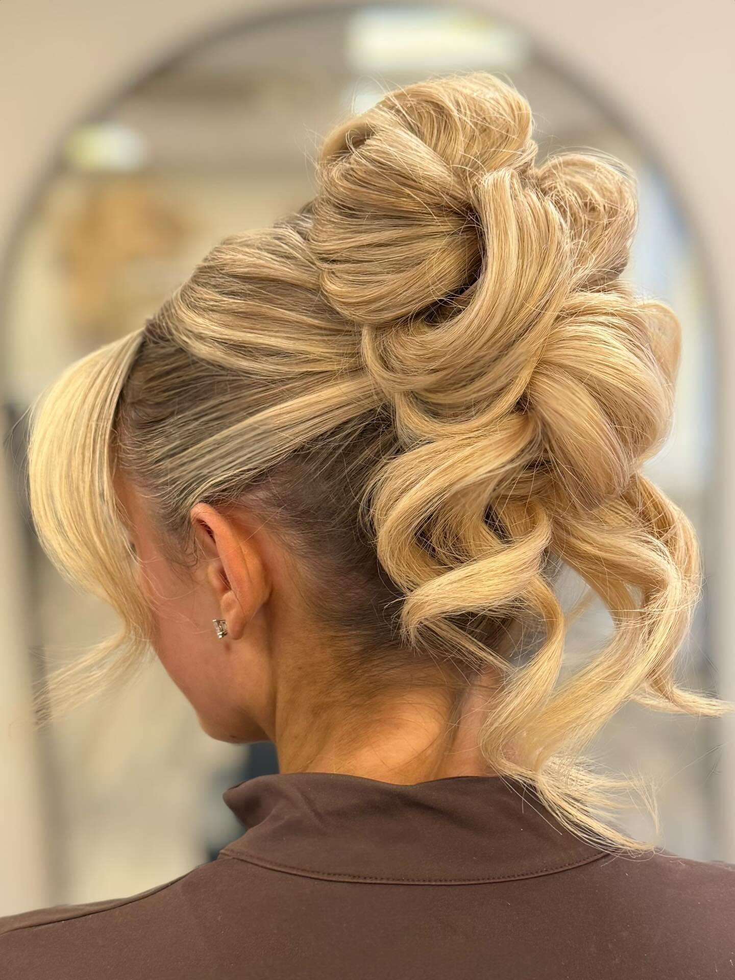 Elegant Cascading Blonde Updo with Spiral Twists