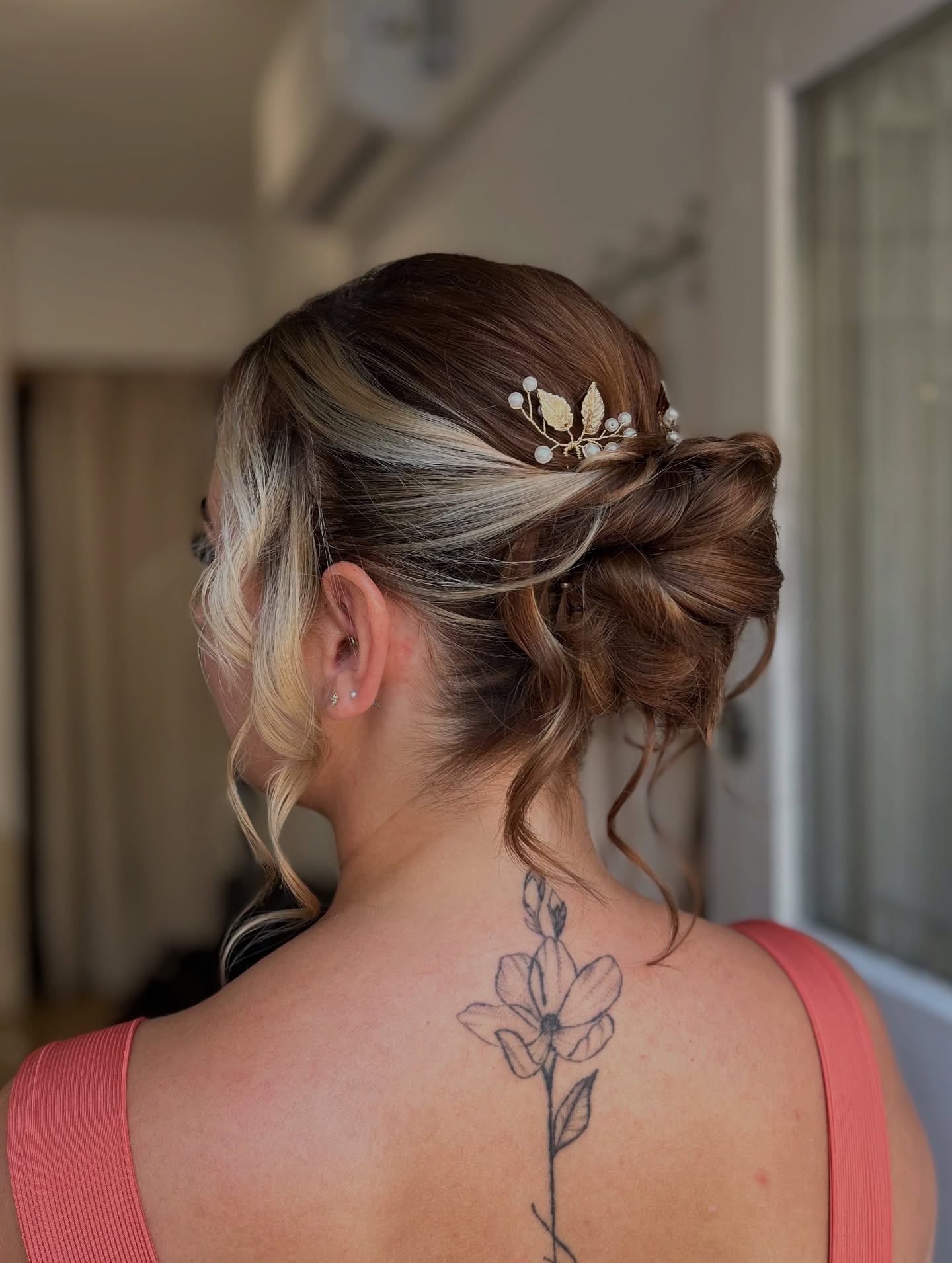 Elegant Tousled Low Bun with Delicate Gold Leaf Hairpiece