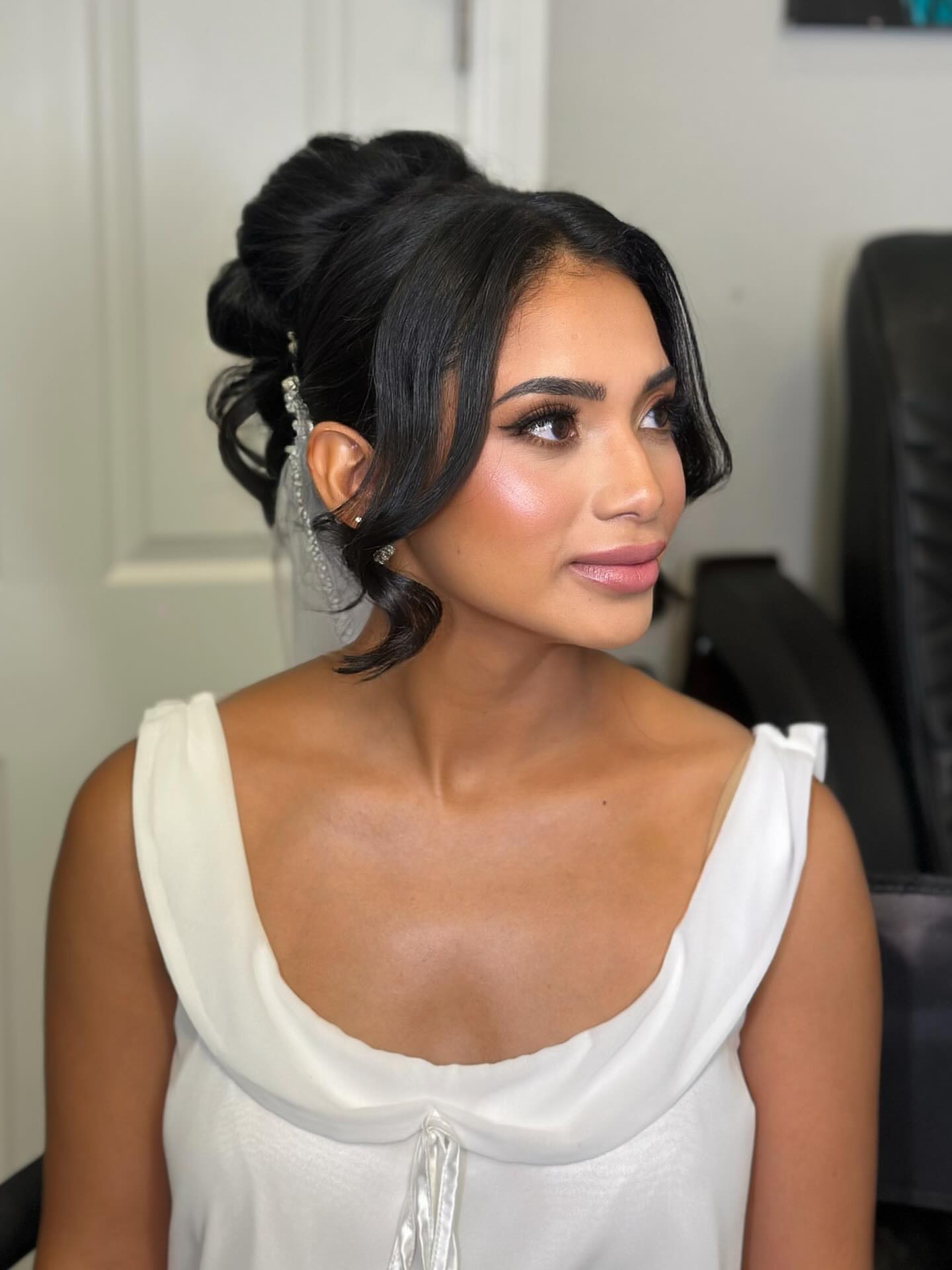 Elegant Updo with Spiral Twists and Loose Tendrils