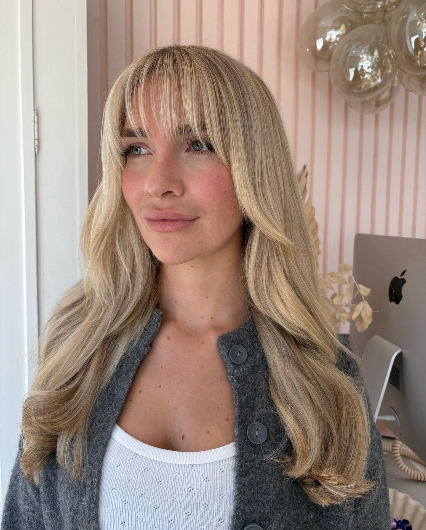 Light Blonde Layered Hair with Feathered Bangs