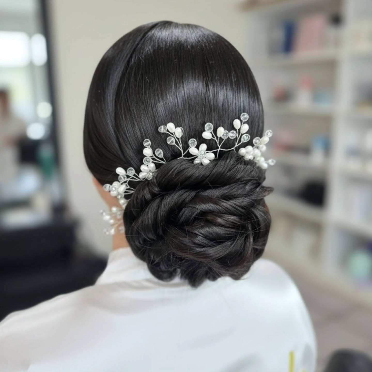 Polished Twisted Low Bun with Delicate Floral Accessories