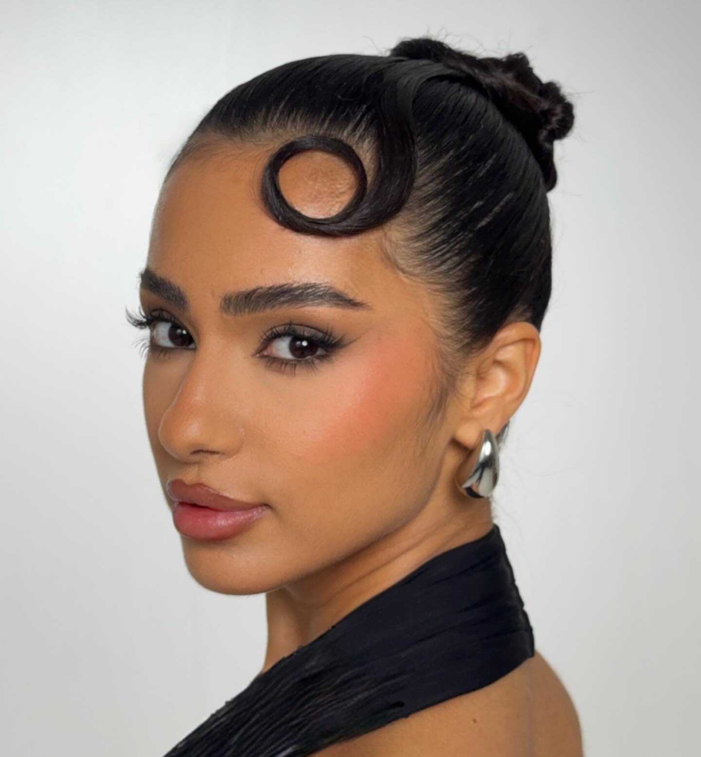Sleek Sculpted Updo with Elegant Loop Accent