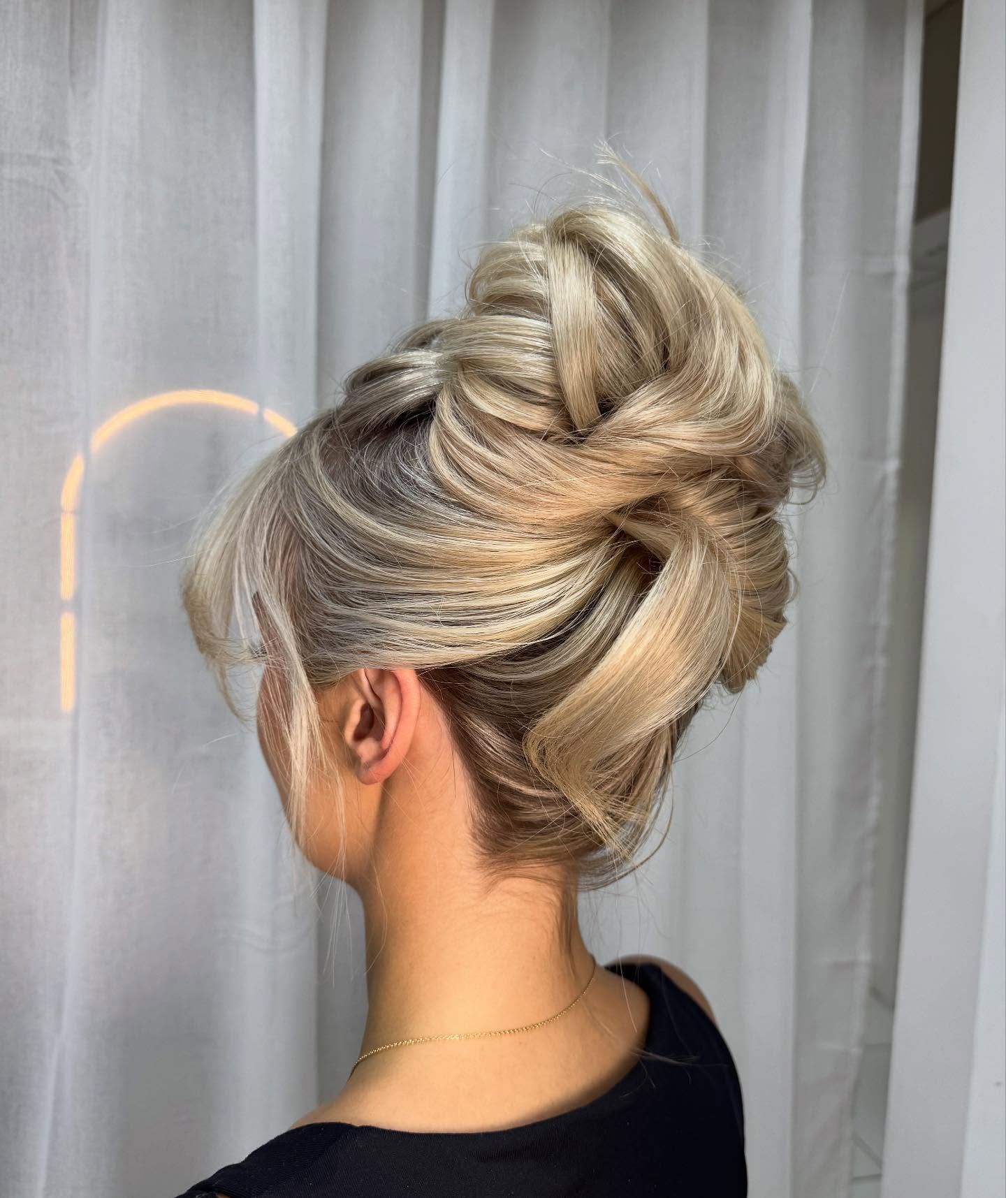 Sumptuous Swirled Blonde Updo with Subtle Highlights