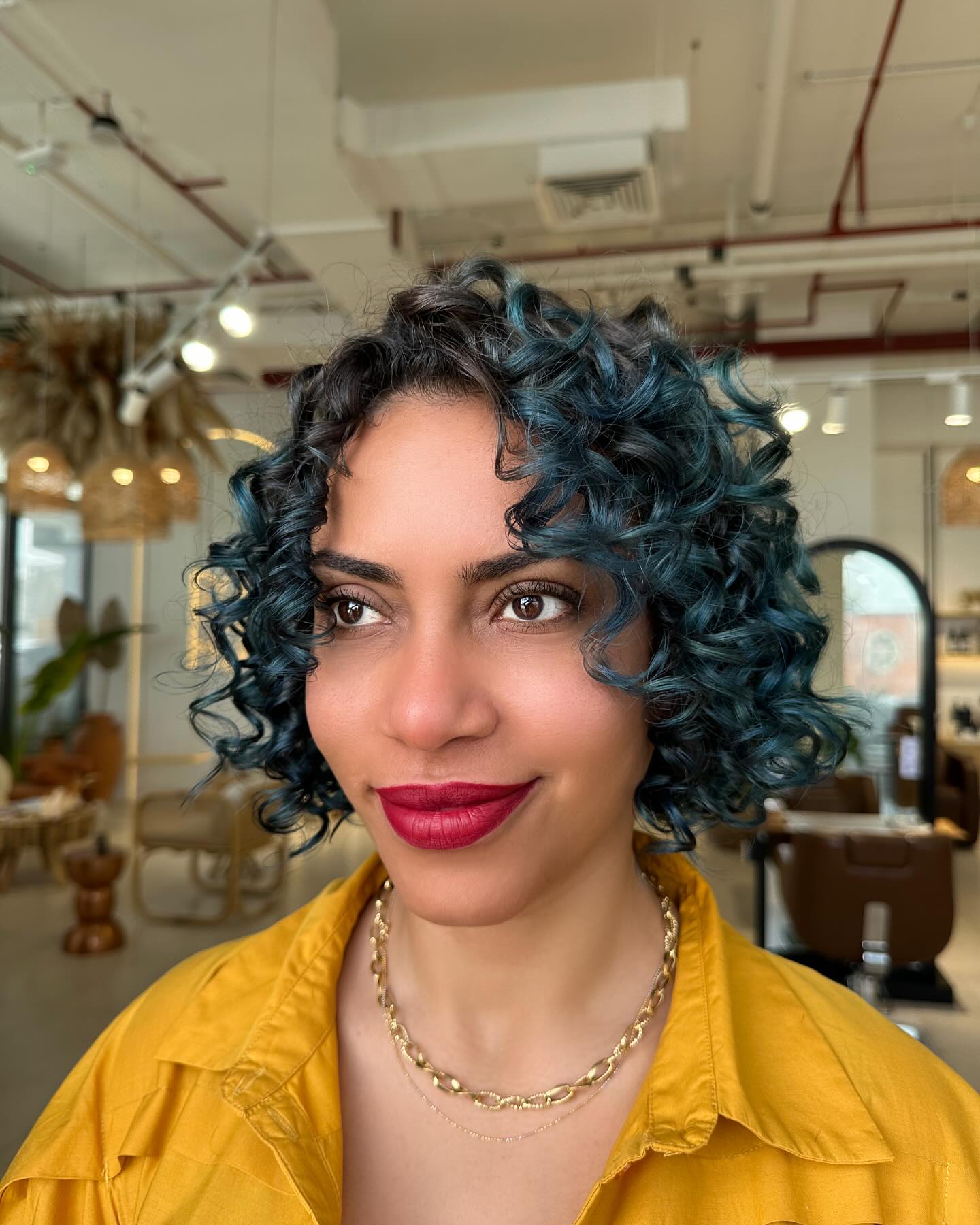 Chic Teal Tousled Curls with Subtle Undercut