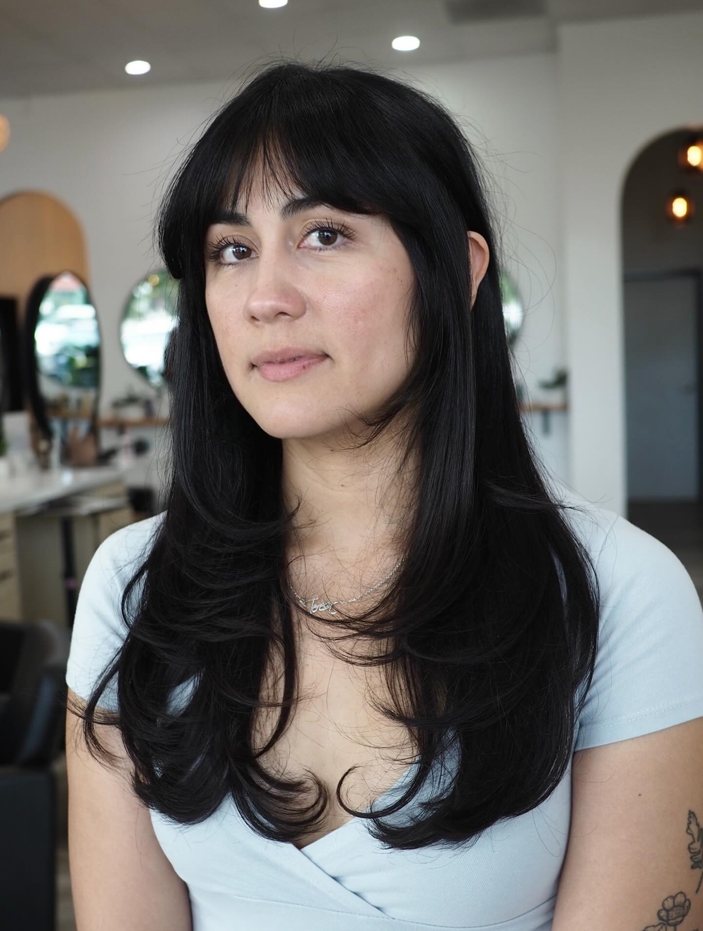 Sleek Midnight Layers with Defined Face-Framing Bangs