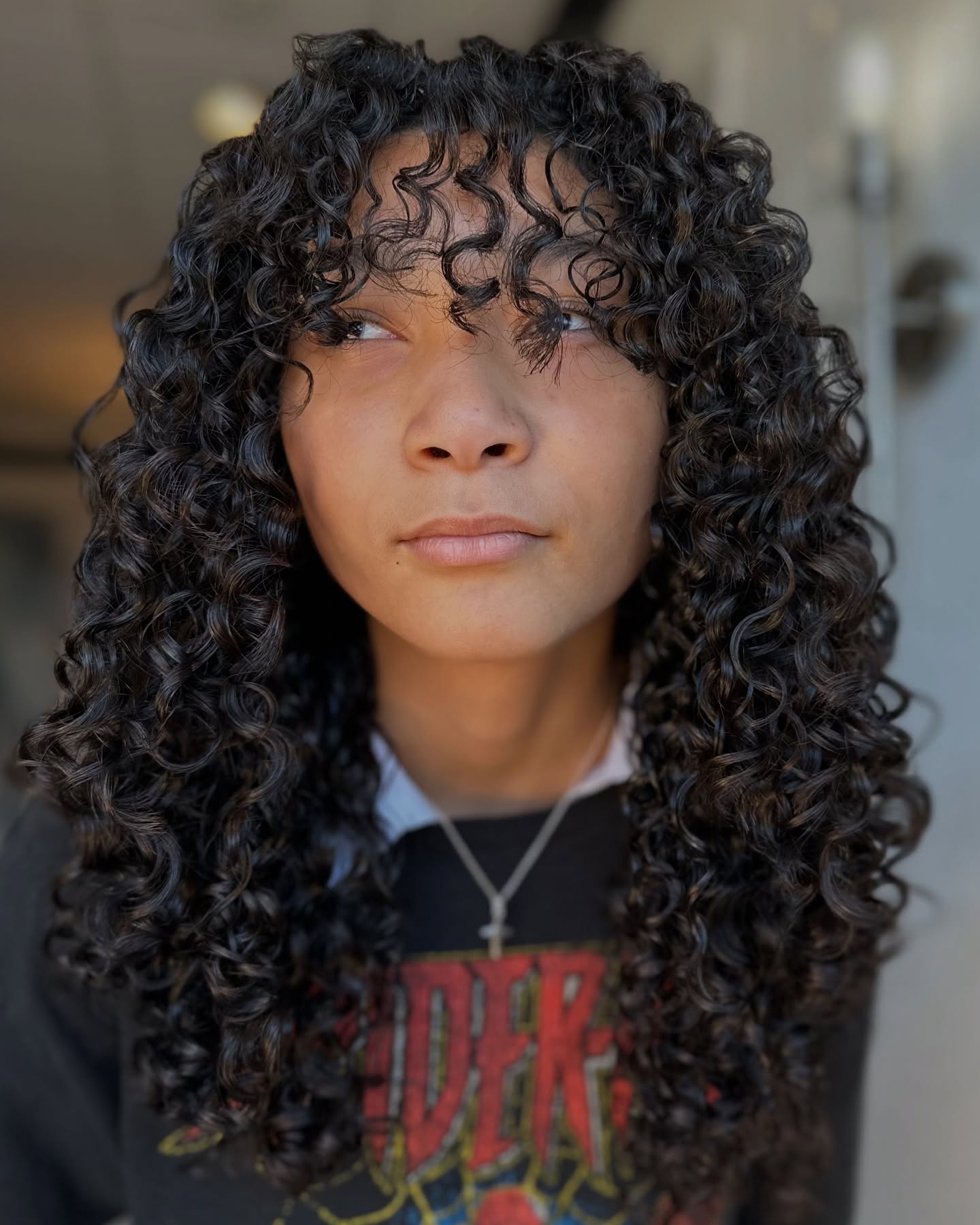 Voluminous Curly Wolf Cut with Face-Framing Layers